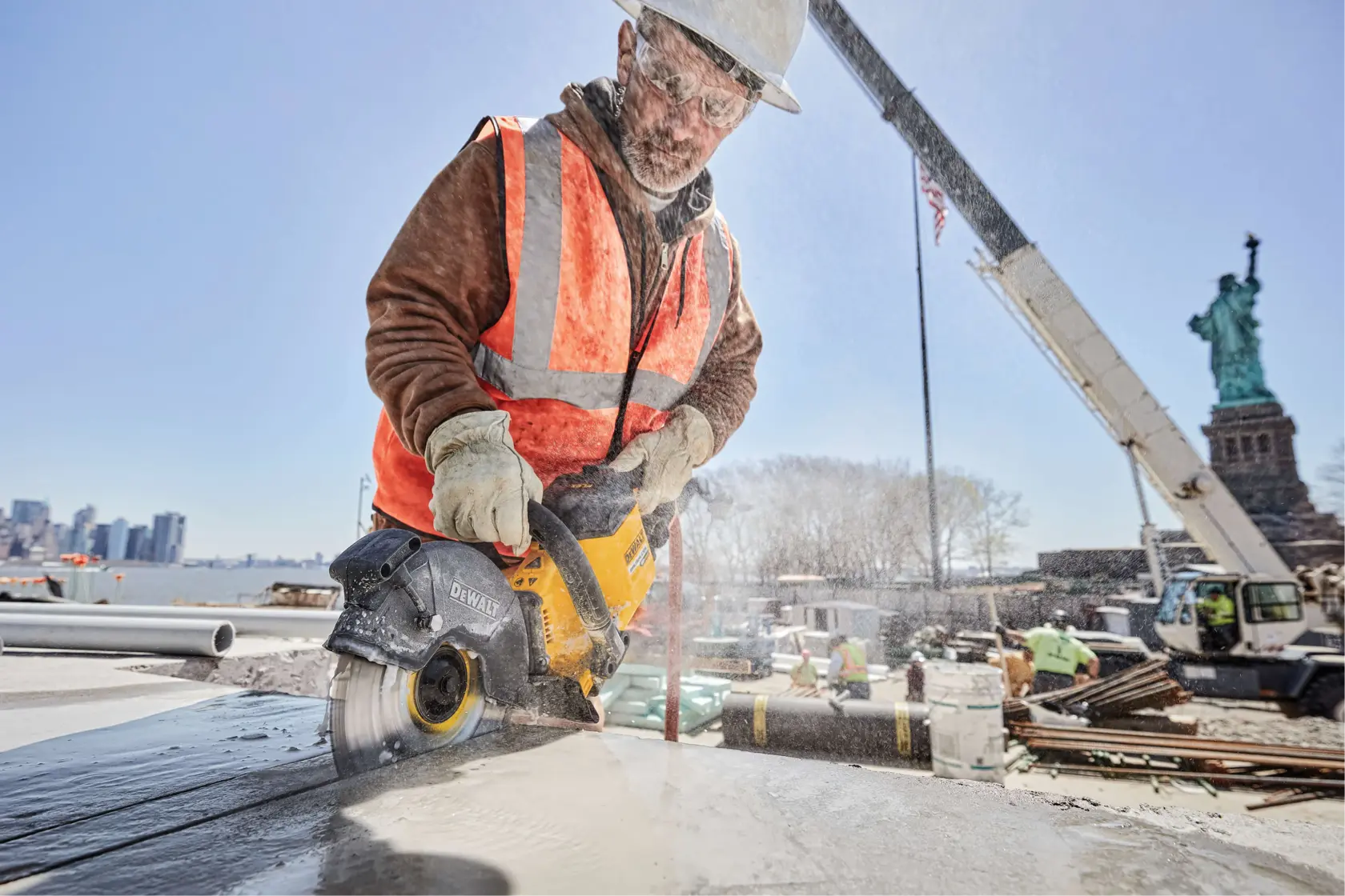 FLEXVOLT DIAMOND CUTTING WHEEL being used by worker to cut through cemented surface at construction site.