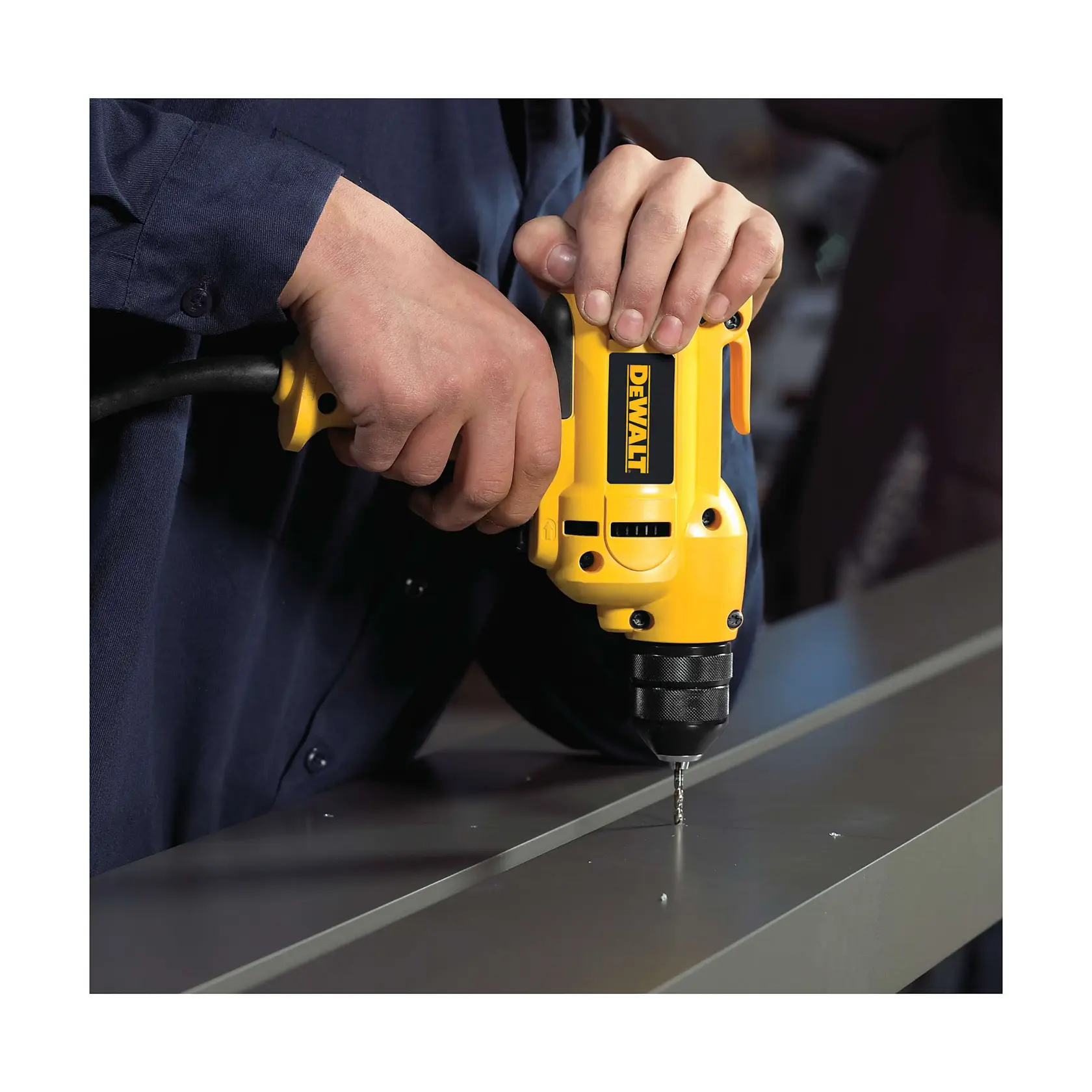 A person using a yellow DEWALT electric drill to drill into a metal surface.