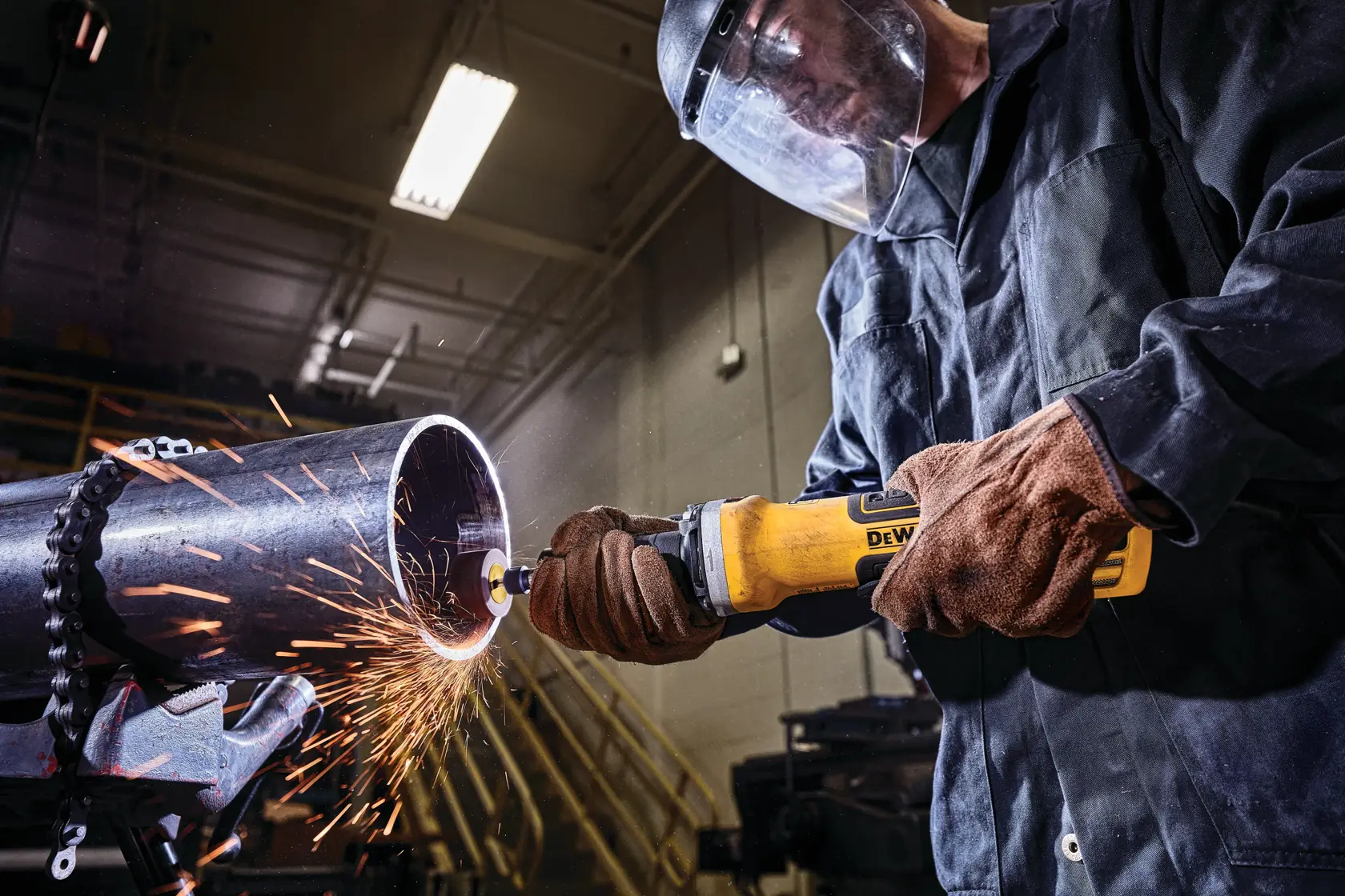 2 inch brushless variable speed paddle switch die grinder with lock-on grinding on a rusted metal structure.