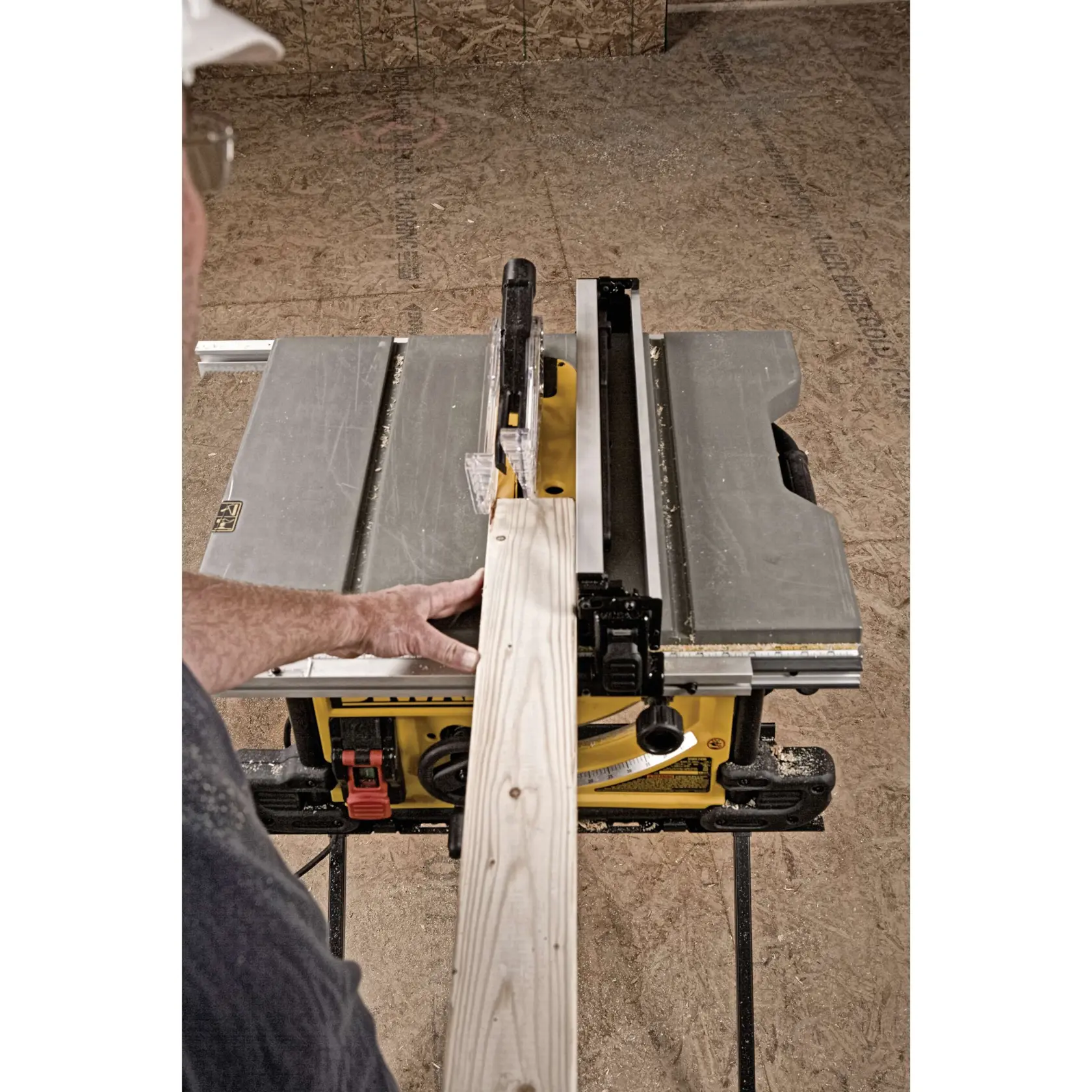 Table saw with scissor stand cutting wooden plank.