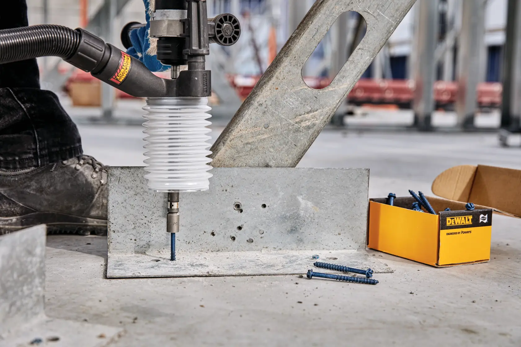 Close up of Dust extraction tube kit with hose drilling drywall.
