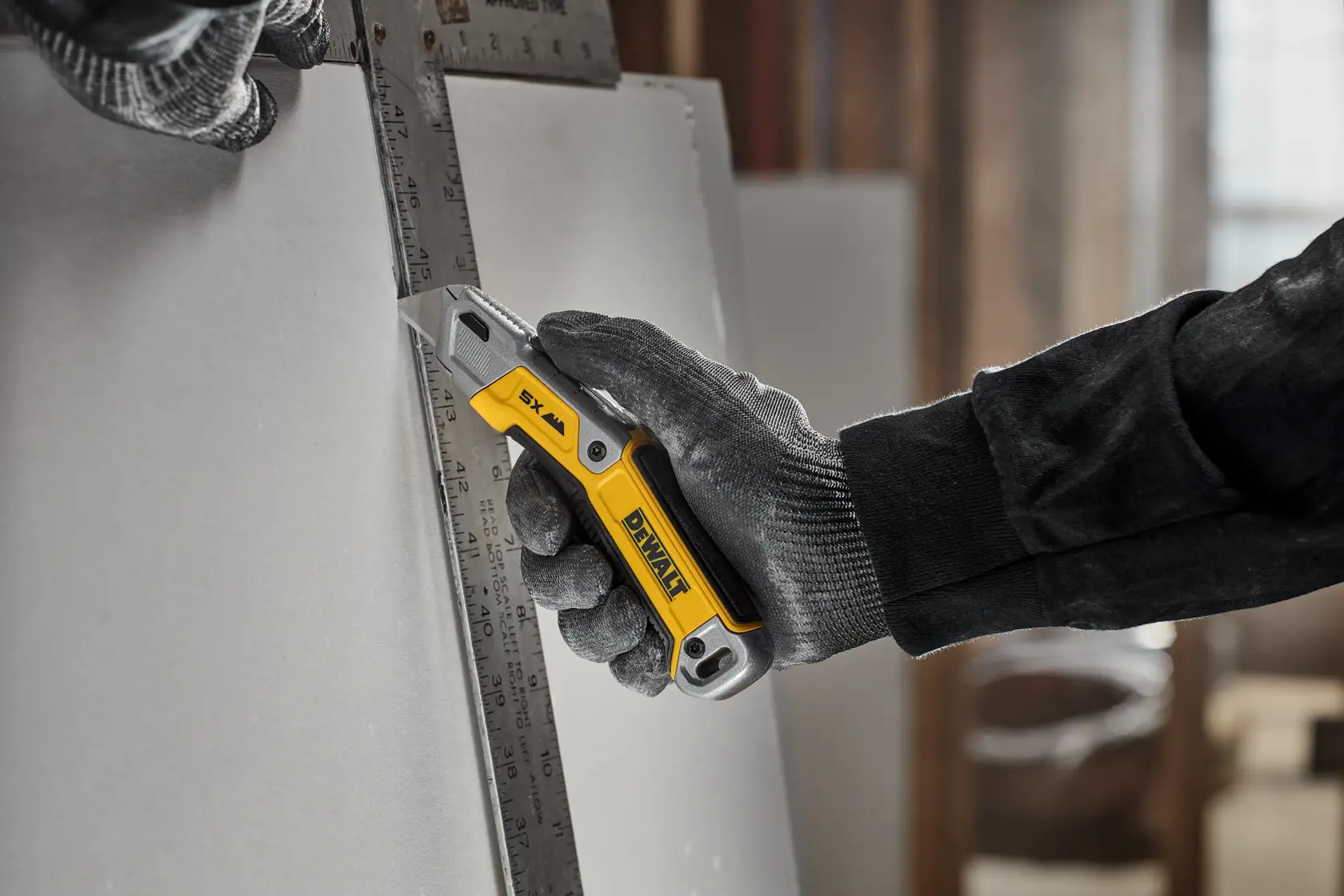 Worker cutting drywall with DEWALT® DWHT10998 Utility Knife 
