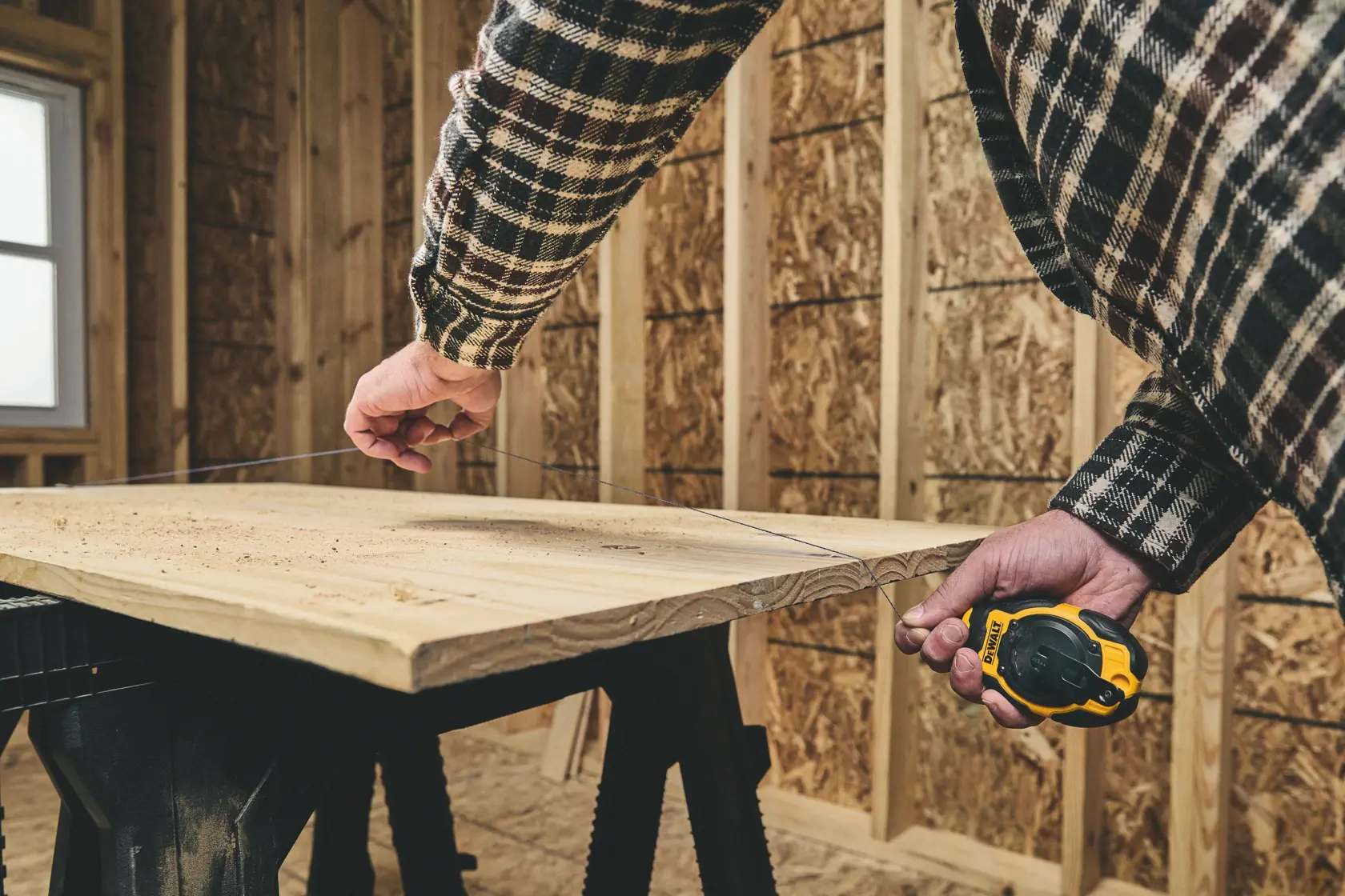 Snapping a line on the DEWALT® Compact Chalk Reel Kit (Blue)