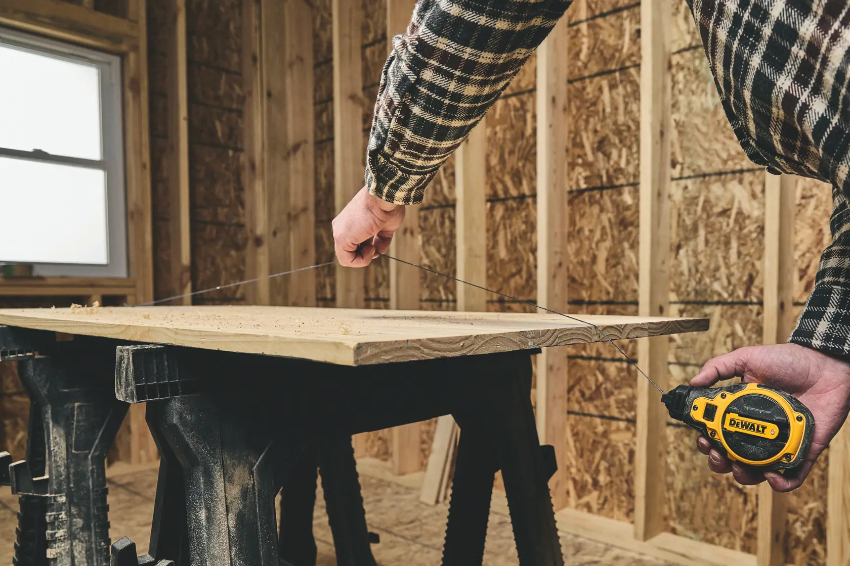 Snapping a line on the DEWALT® Bi-Material Chalk Reel Kit (Blue)