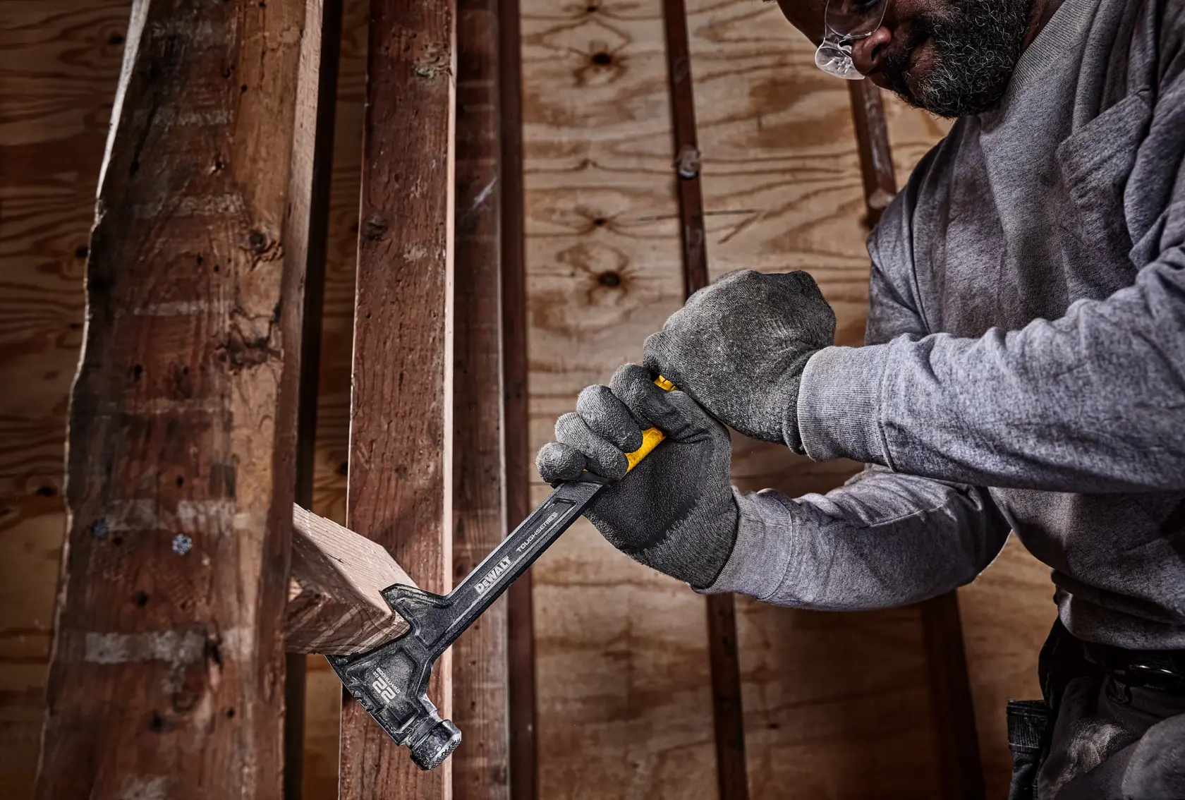 22 ounce demolition hammer being used remove a block of wood from between two long columns.