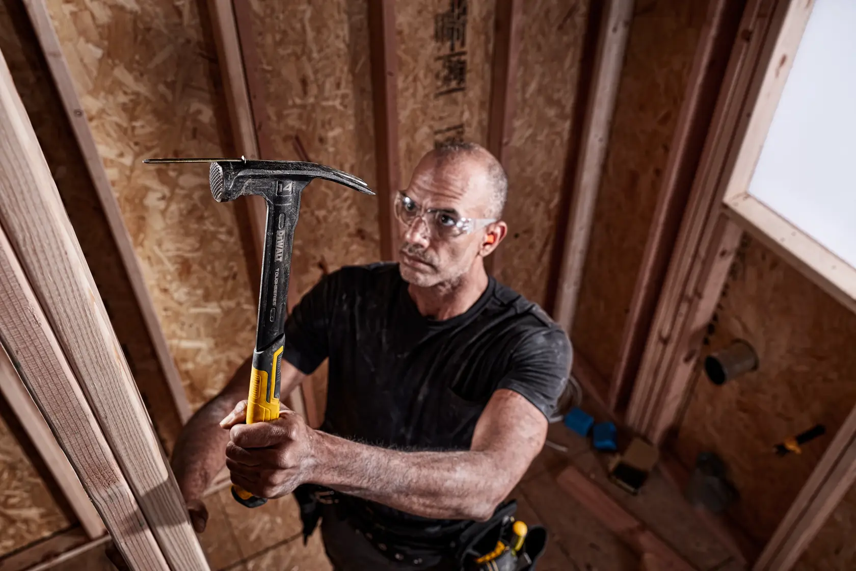 XP 1 Piece Steel 14 ounce MIG Weld Framing Hammer being used by a person with nail.