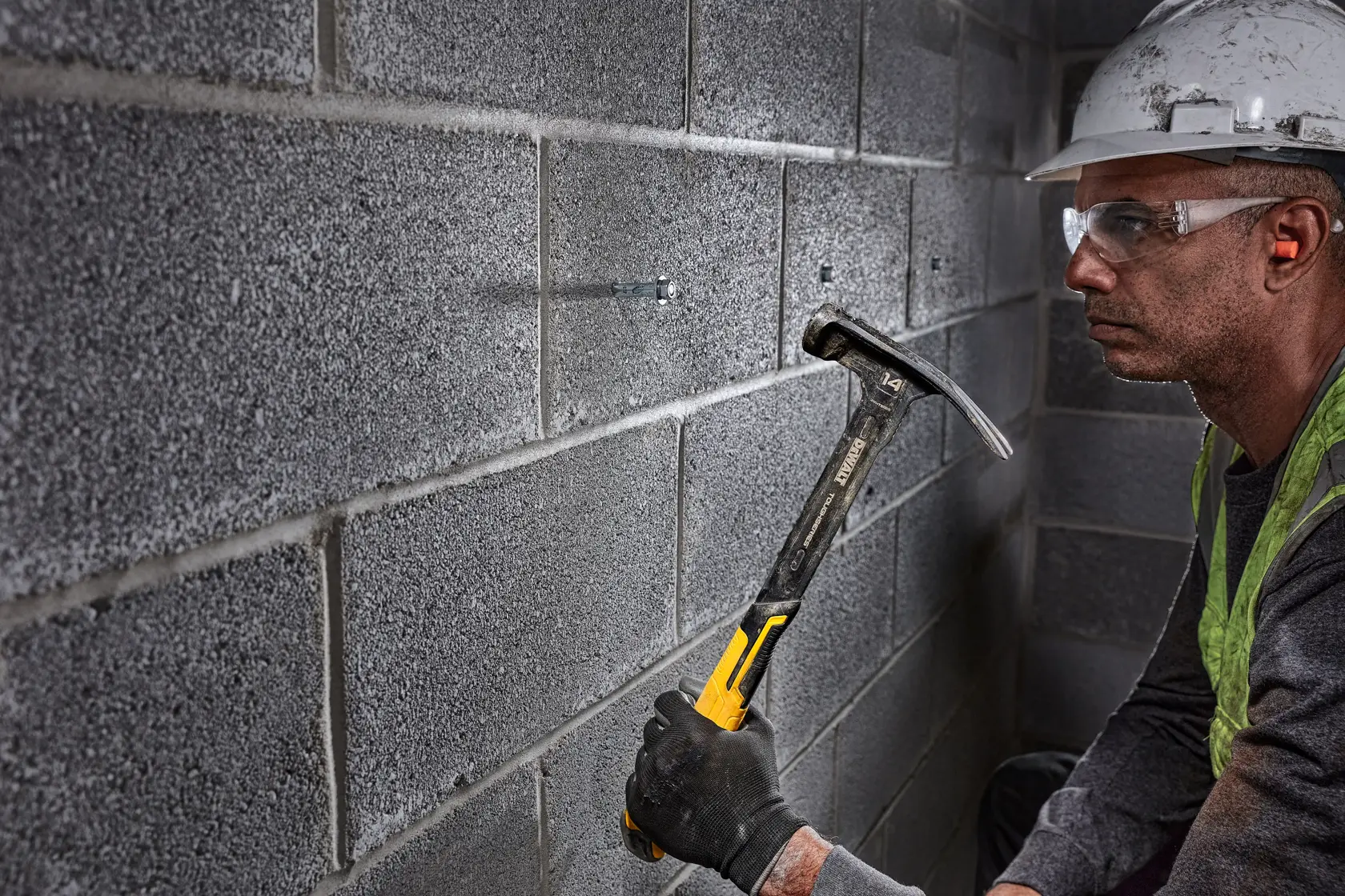 XP 1 Piece Steel 14 ounce MIG Weld Framing Hammer being used by a person on bolt in wall.