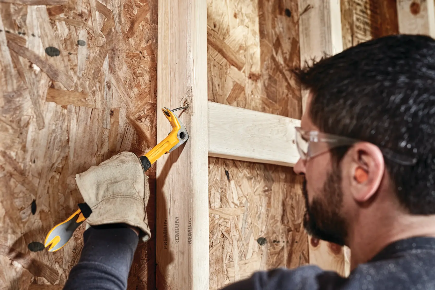 12 inch Precision Claw Bar being used by a person to pull nail from wood.