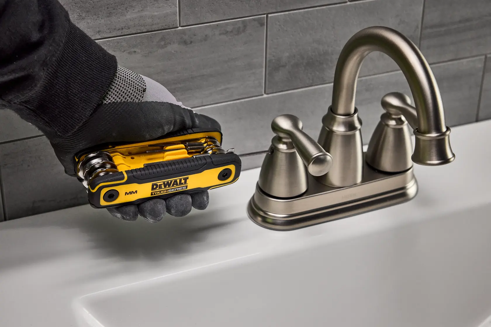 User tightening fastener of sink faucet with the DEWALT TOUGHSERIES MM Folding Locking Hex Key