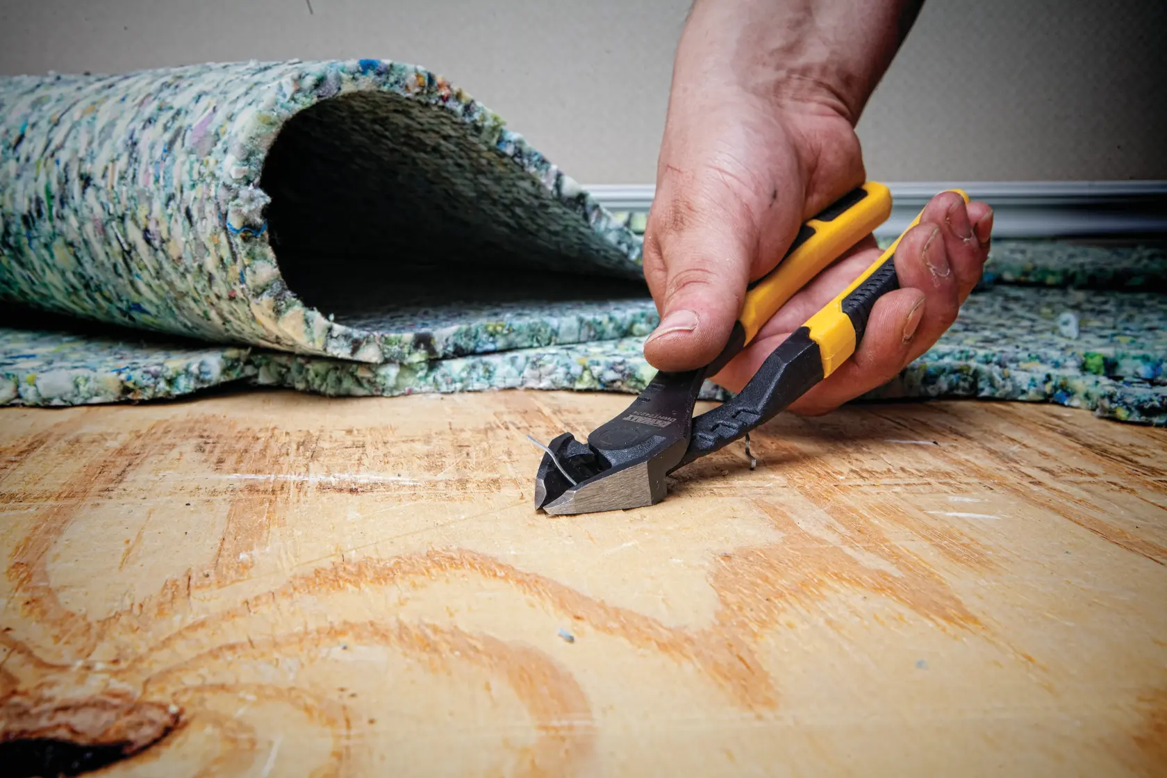8 inch Diagonal Pliers with Prying Tip being used on metal wires by a person.
