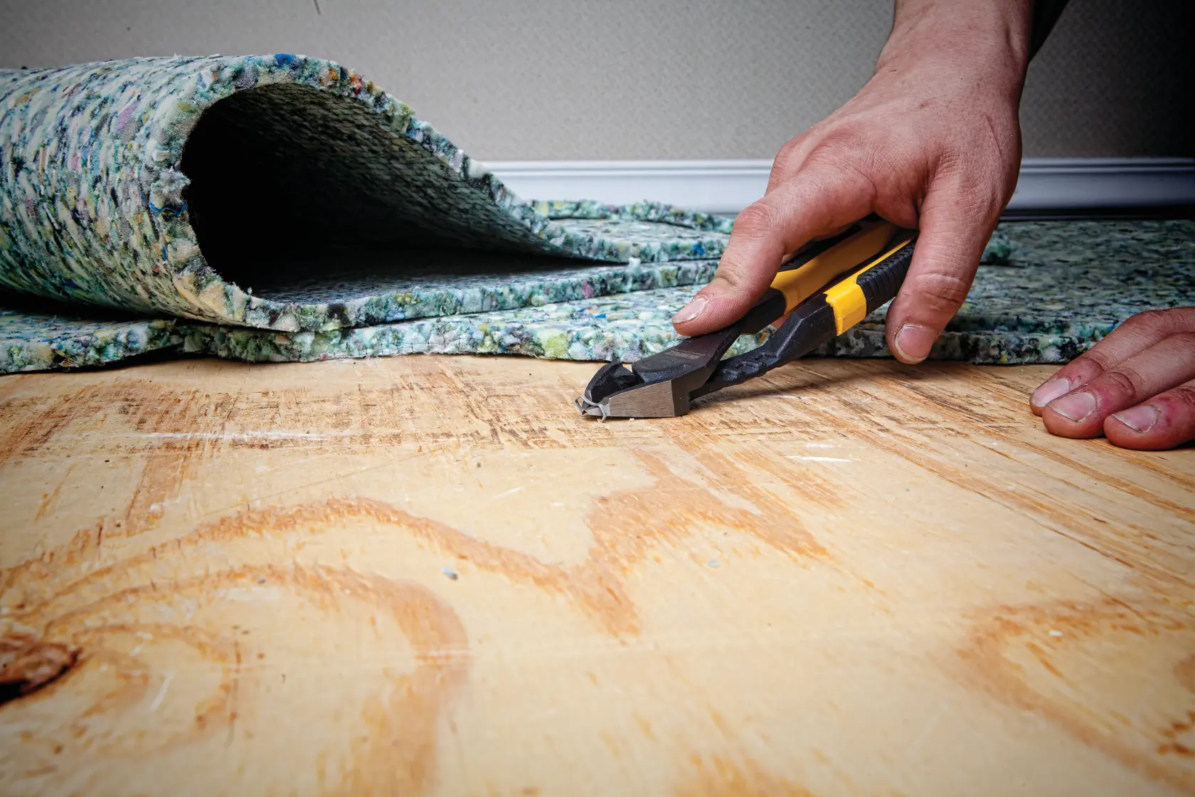 8 inch Diagonal Pliers with Prying Tip being used on  floor by a person.