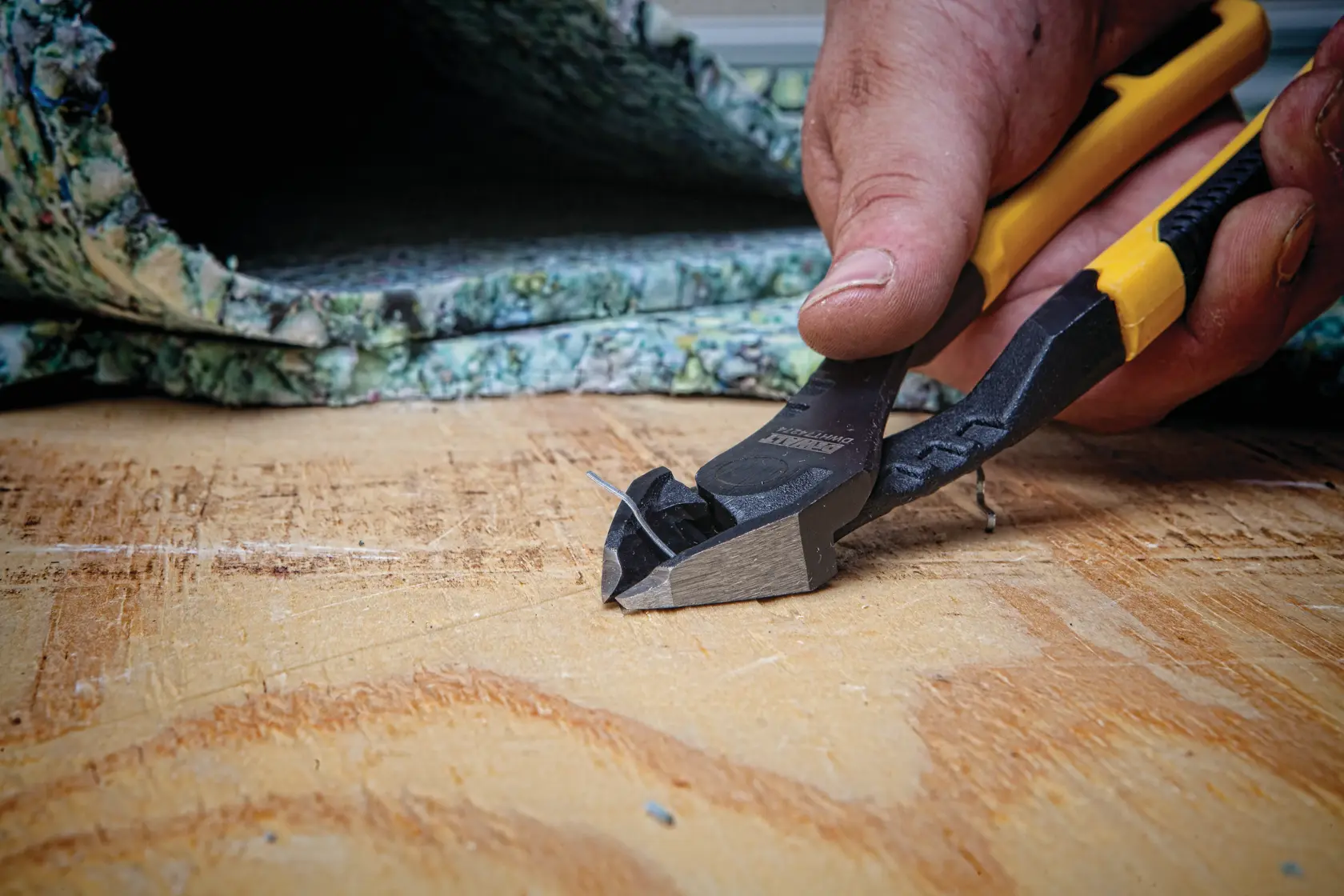 8 inch Diagonal Pliers with Prying Tip being used on metal wires by a person.