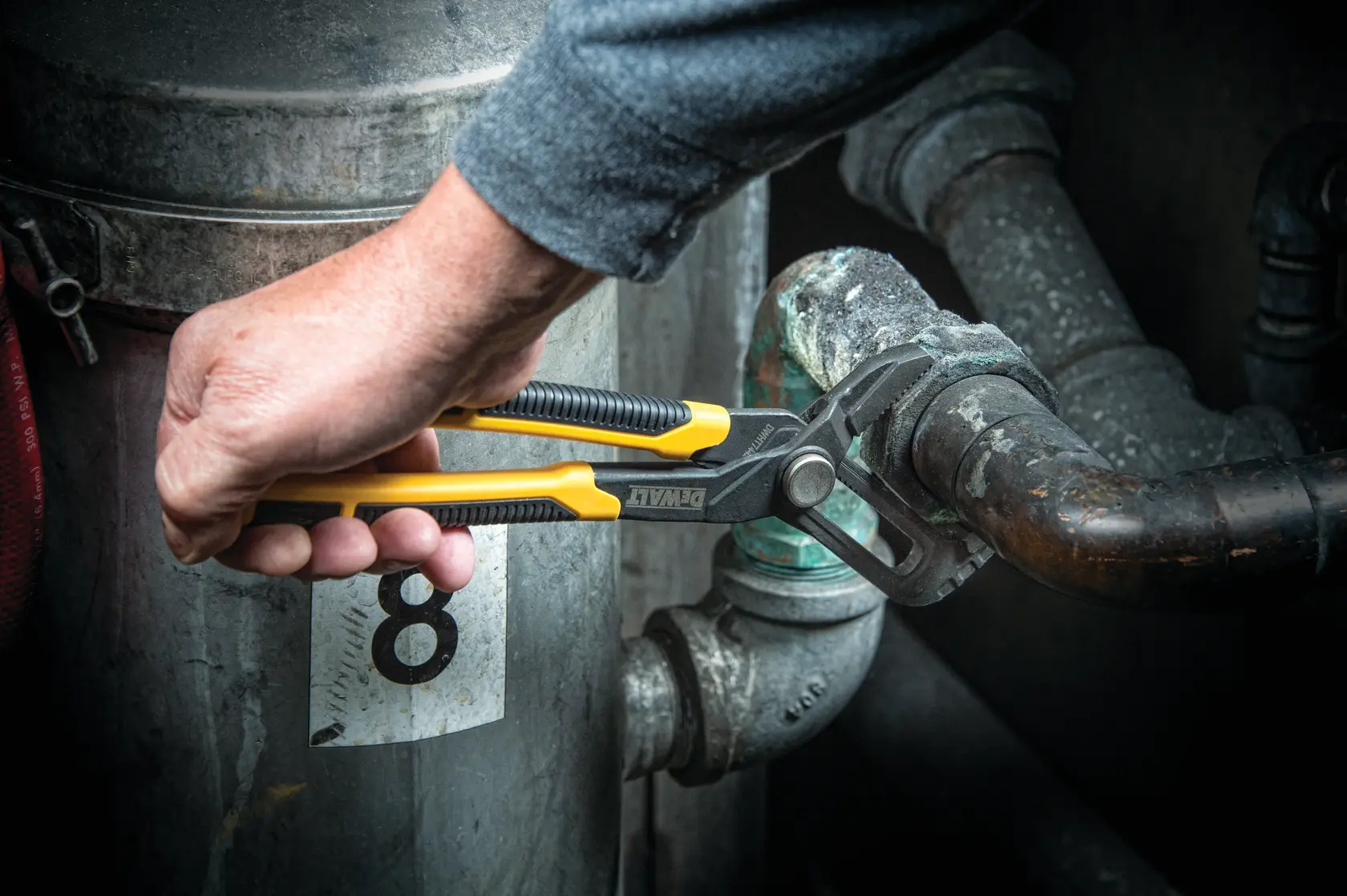 Close up of  10 inch Straight Jaw Pushlock Pliers being used on a metal tube.