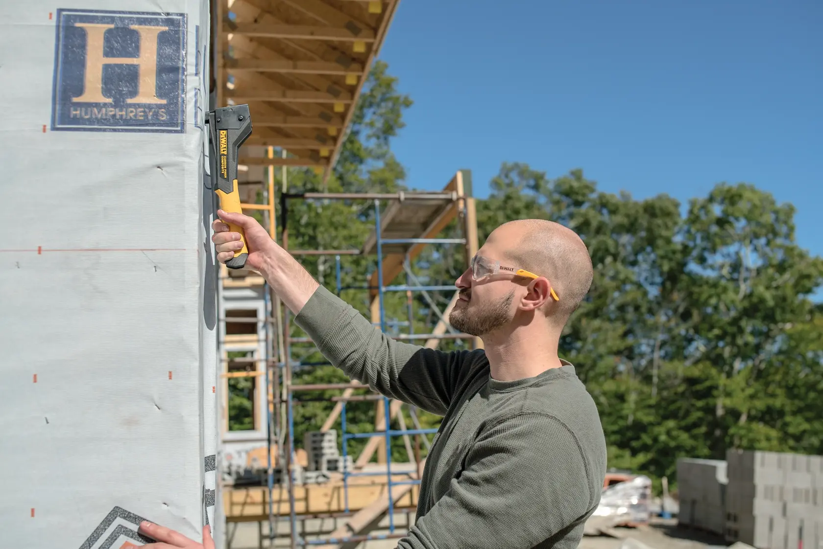 Carbon Fiber Composite Hammer Tacker being used on a construction site by a person.