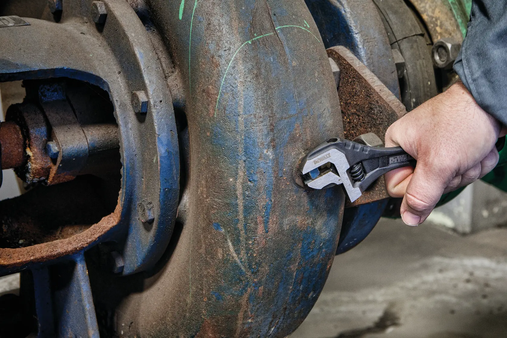 Close up of  8 inch All Steel Adjustable Wrench being used to adjust screws on a machine.