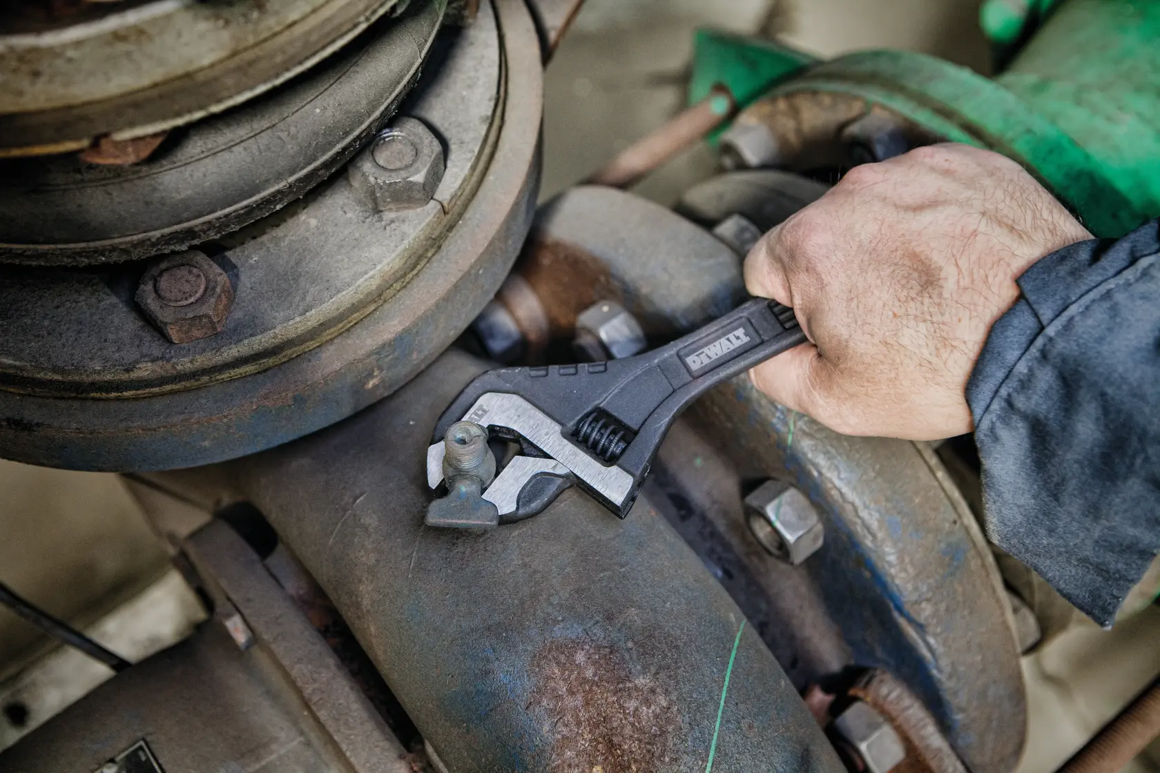 Close up of  8 inch All Steel Adjustable Wrench being used to adjust bolts on a machine.