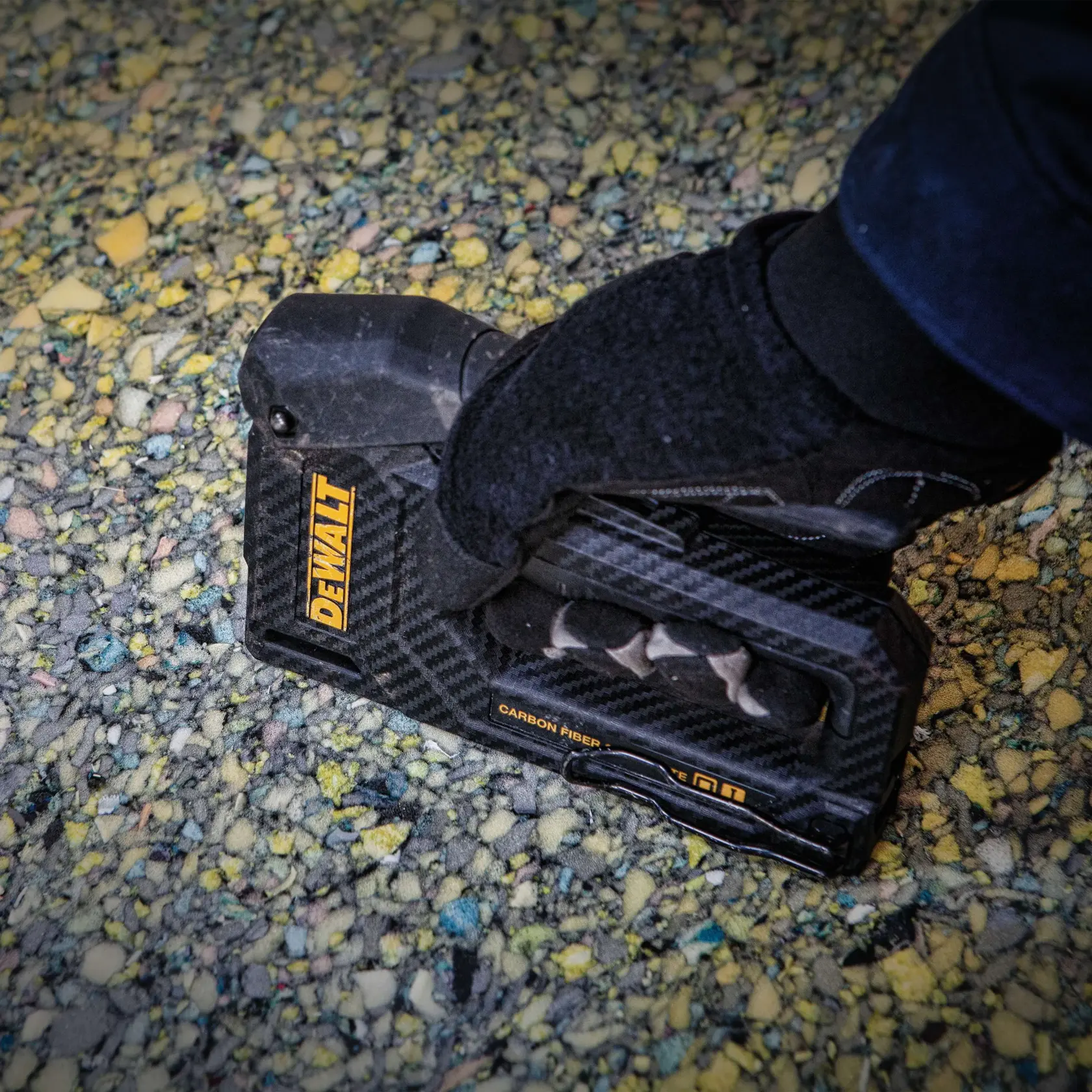 Close up of  Carbon Fiber Composite Staple Gun being used to staple material.