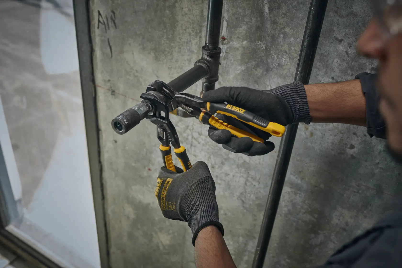 DEWALT Slidelock Pliers in use on a pipe