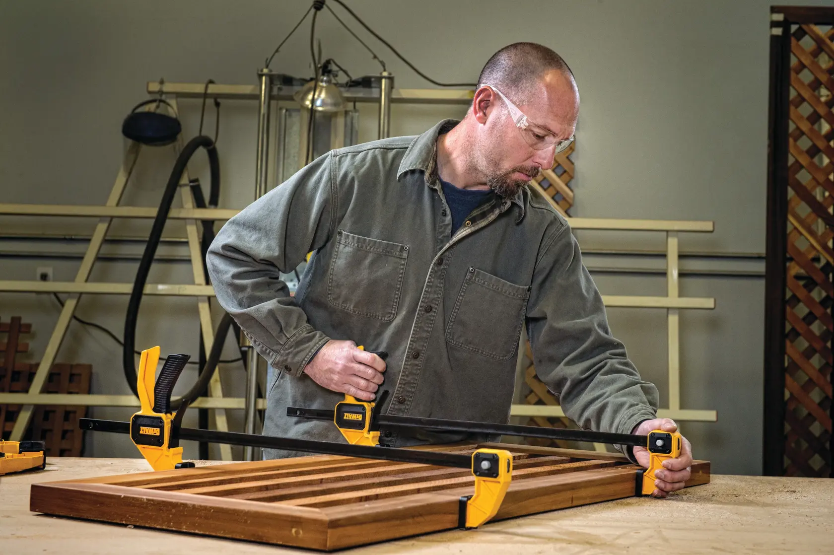24 inch Large Trigger Clamp being used on a wooden structure by a person.