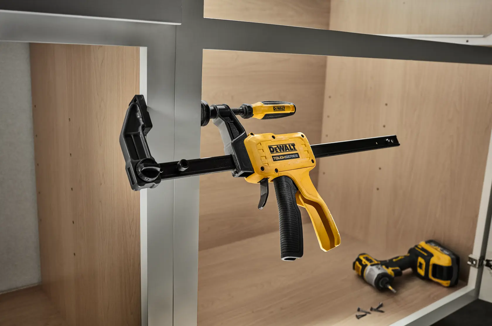 DEWALT 12“ Large Hybrid Clamp securing two cabinets together