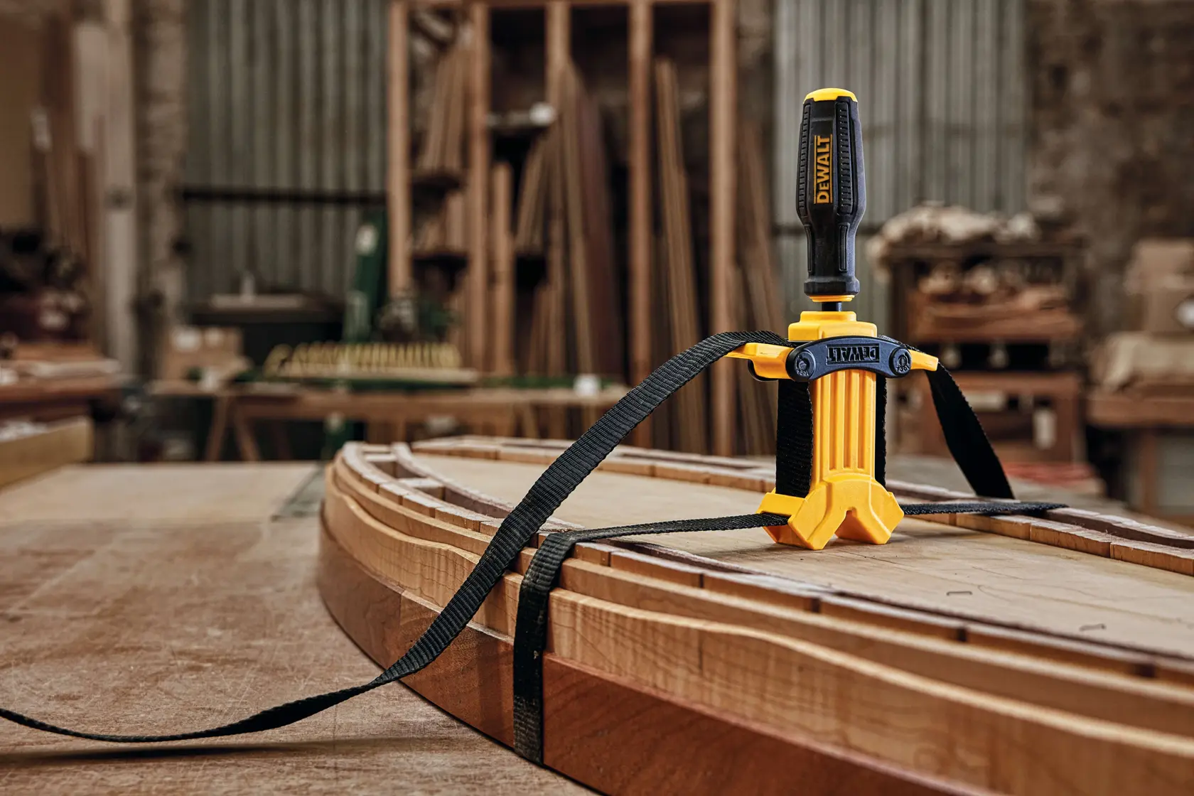 Profile of  15 foot Band Clamp being used on wooden structures in a workshop.
