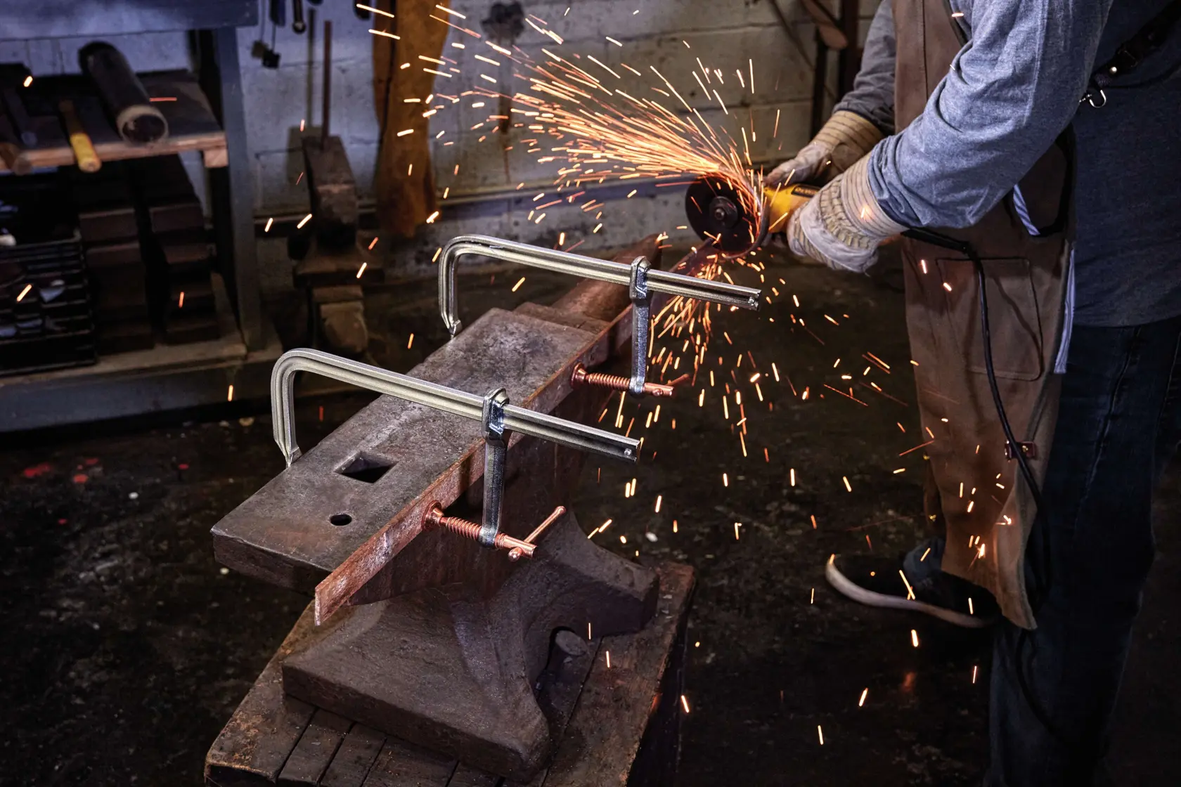 12 inch Metalworking bar Clamp being used by a person in a workshop.