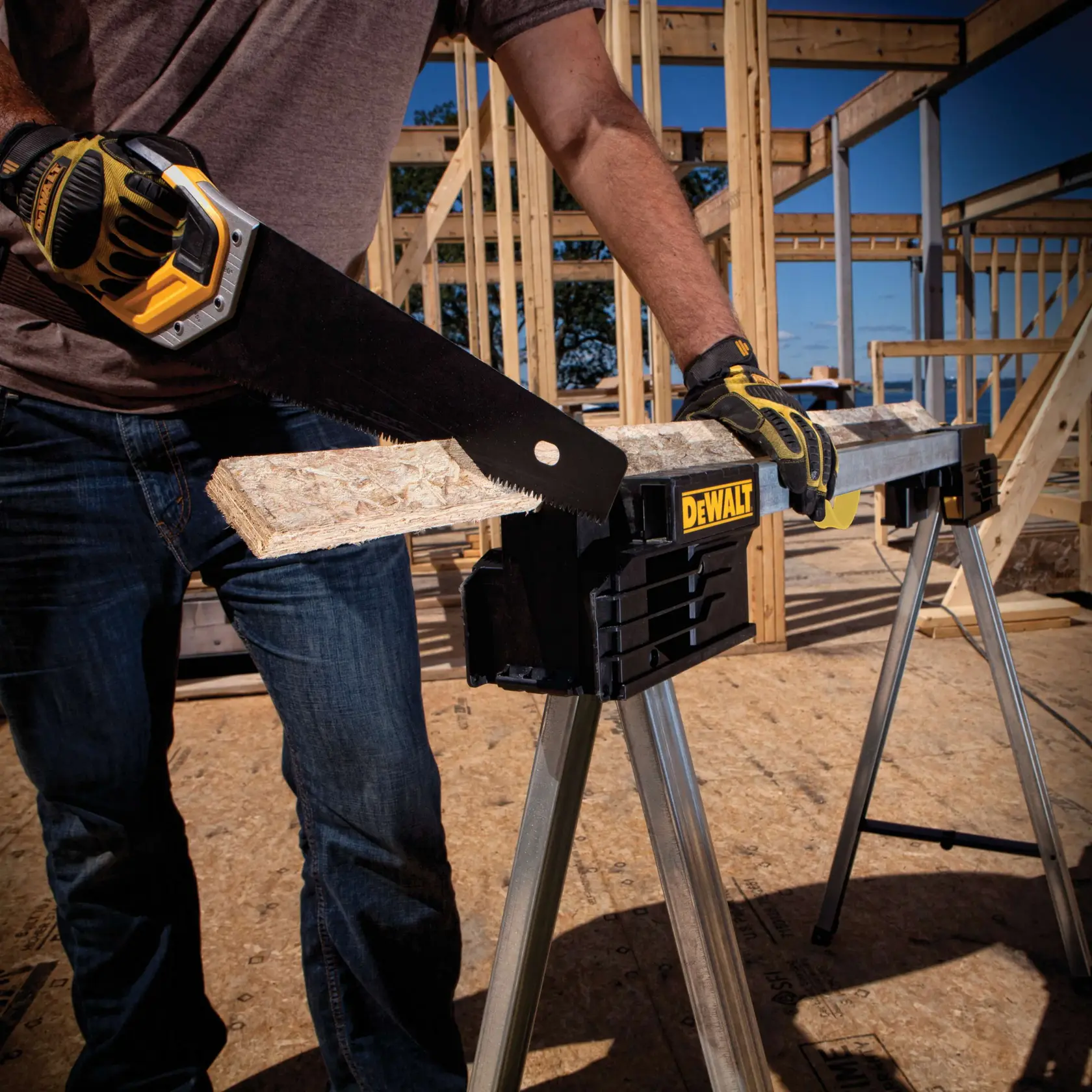 Metal folding sawhorse holding a wooden plank as it is being sawed through.