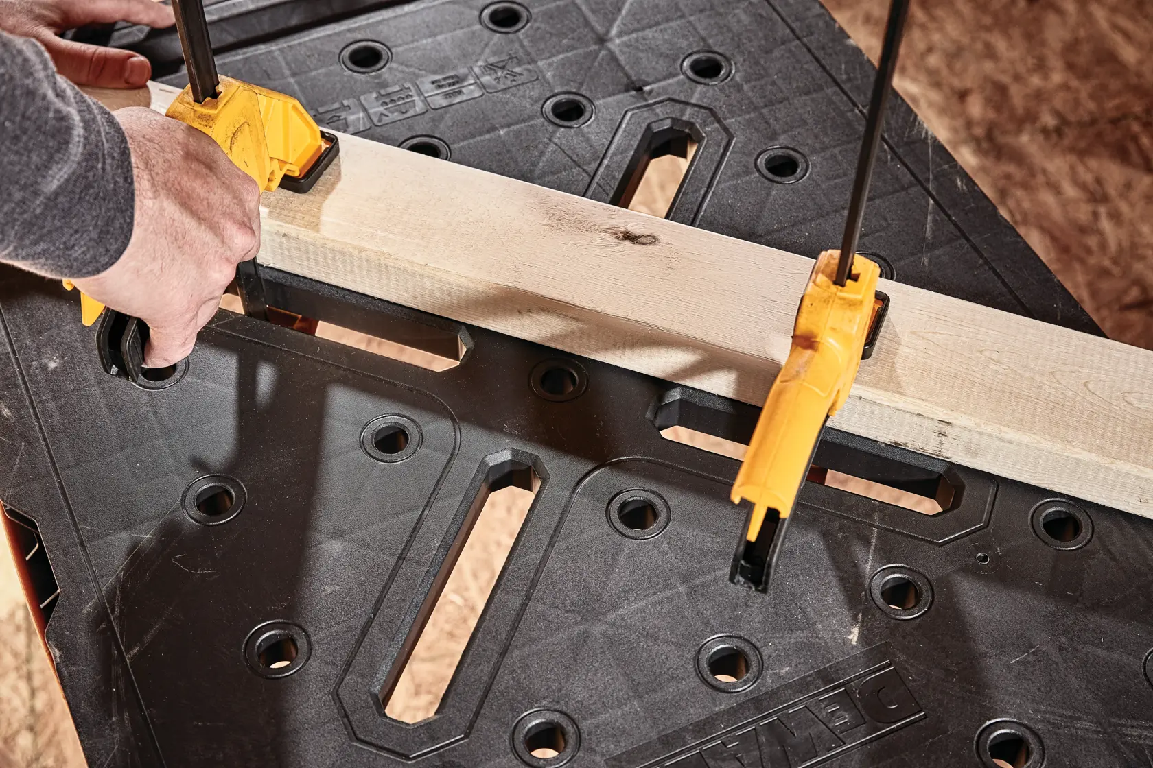 Express folding workbench holding a plank of wood.