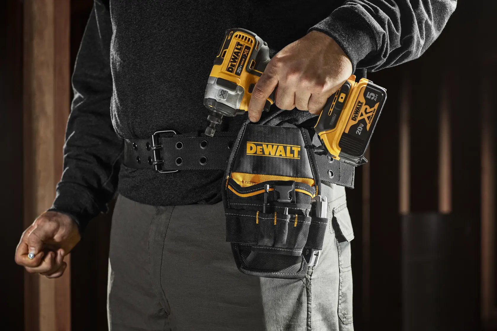 FRAMER WEARING DEWALT PROFESSIONAL NAIL POUCH