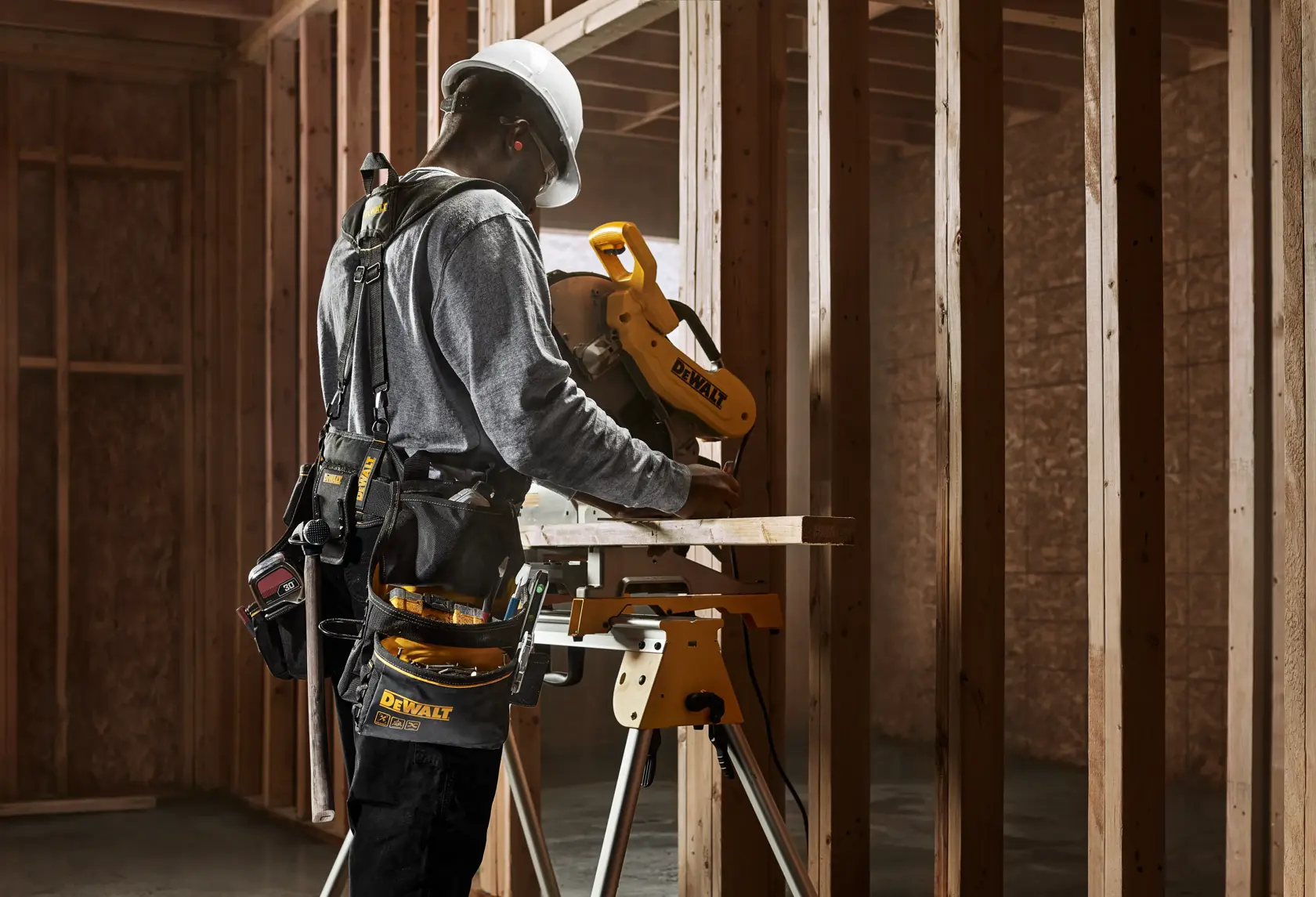 CONSTRUCTION WORKER WEARING DEWALT PROFESSIONAL DRILL HOLSTER