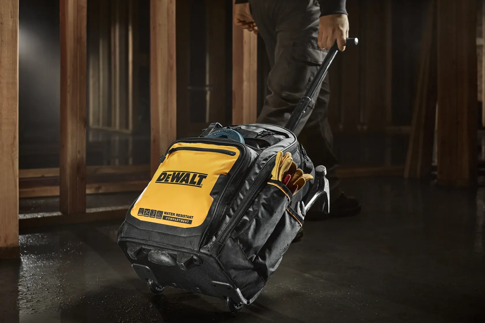 WORKER PULLING DEWALT PROFESSIONAL BACKPACK WITH WHEELS