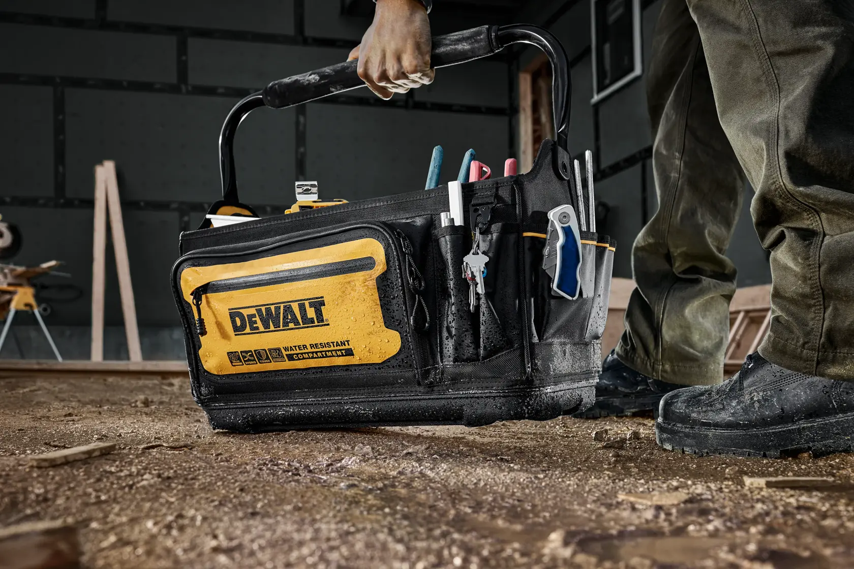 CONSTRUCTION WORKER HOLDING DEWALT 20 INCH PRO TOTE