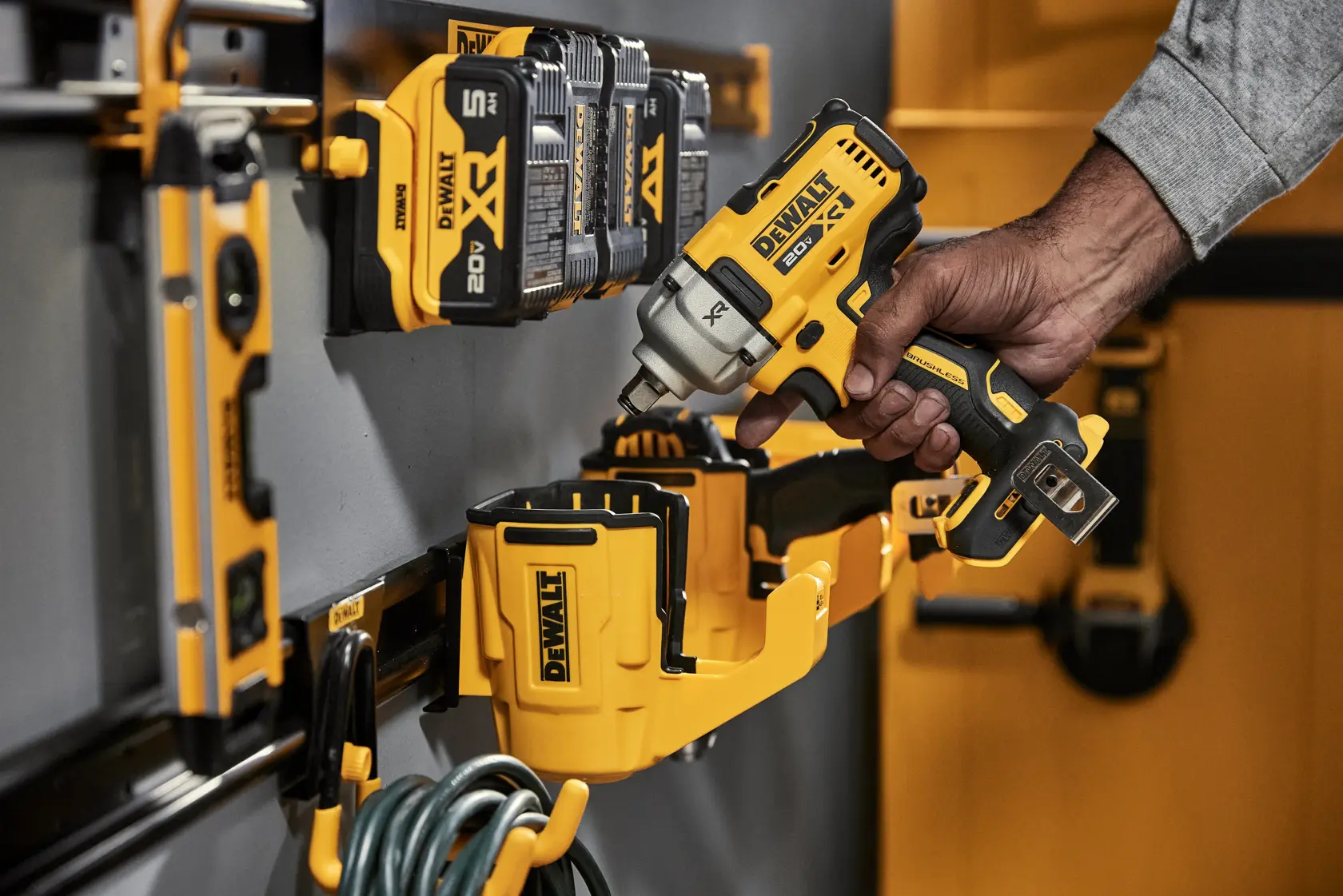 A Person Grabbing a DEWALT Power Tool Out of a DEWALT Power Tool Holster