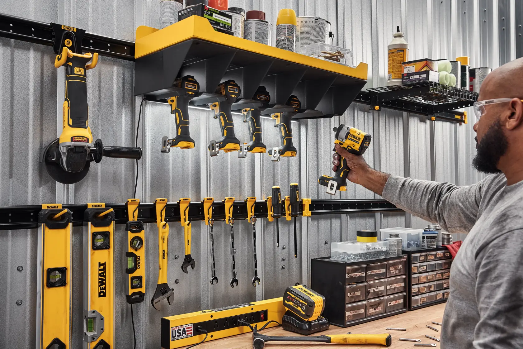 A Person Grabbing a DEWALT Power Tool Out of a DEWALT Power Tool Holster Featuring  Metal Rails, Hand Tools and Accessories.