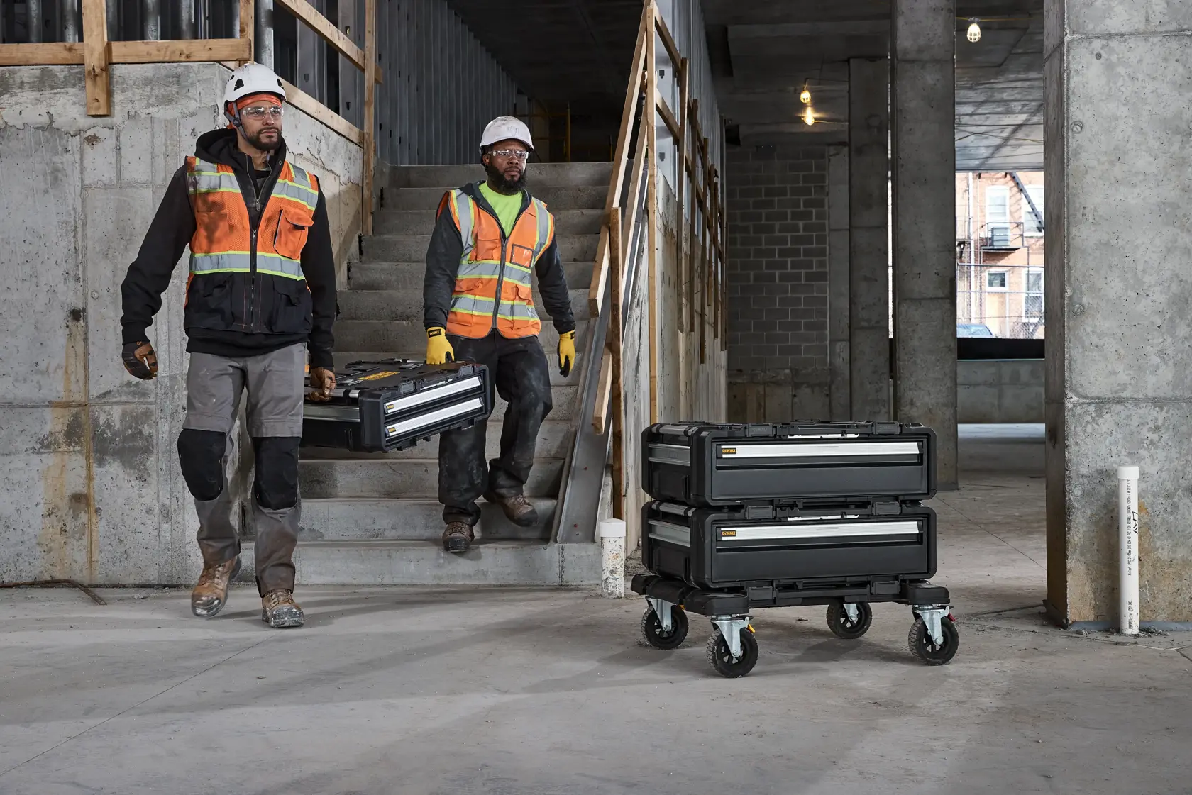 2  people carrying a TOUGHSYSTEM 2.0 DXL 2 drawer unit on a Commercial Site
