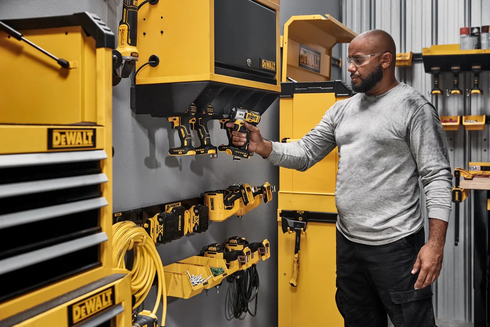 A Person Grabbing a Power Tool out of a Power Tool Holster 
