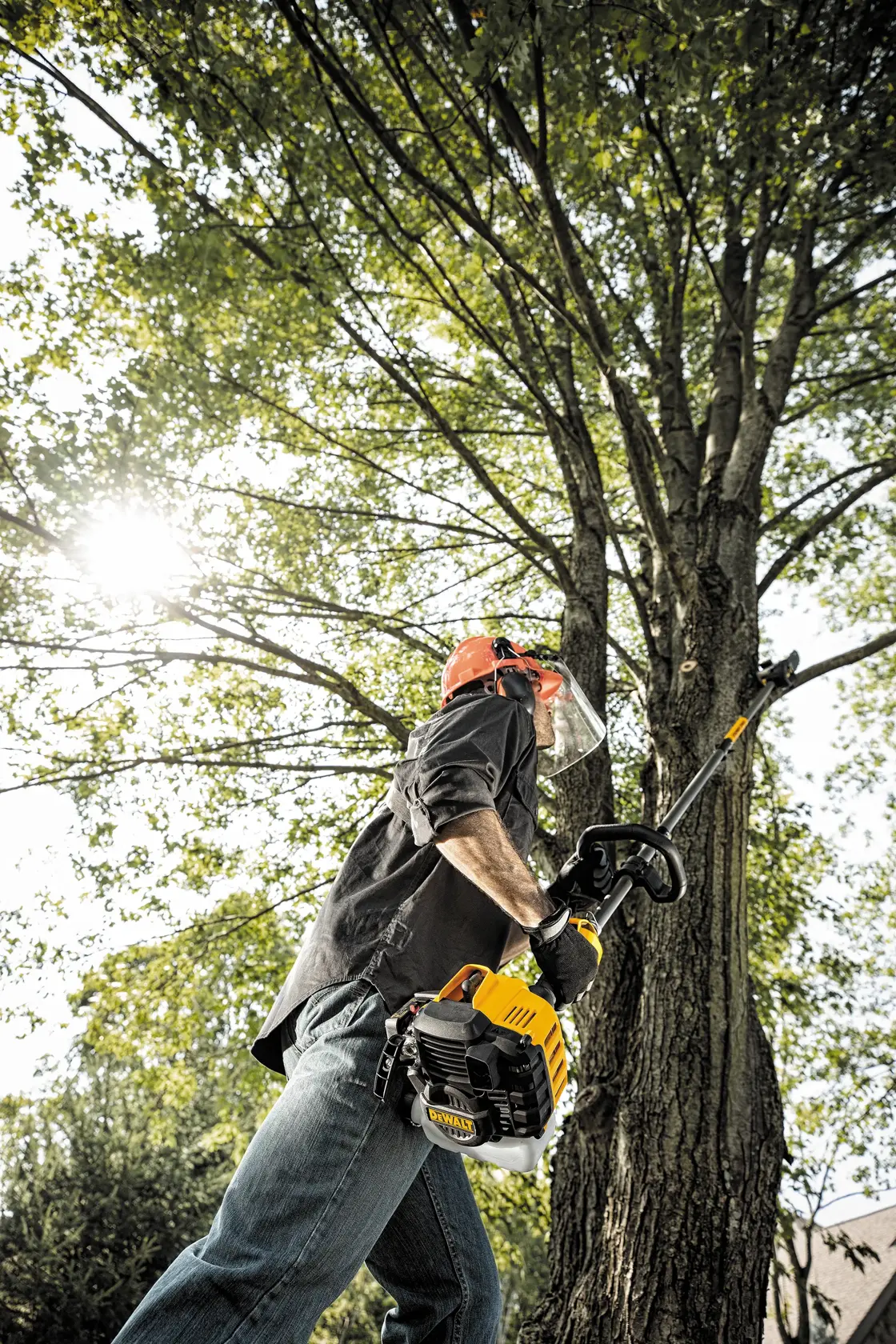 27 cubic centimeters 2 Cycle 10 inch Gas Pole Saw with Attachment Capability being used by worker to cut tree branch outdoors.