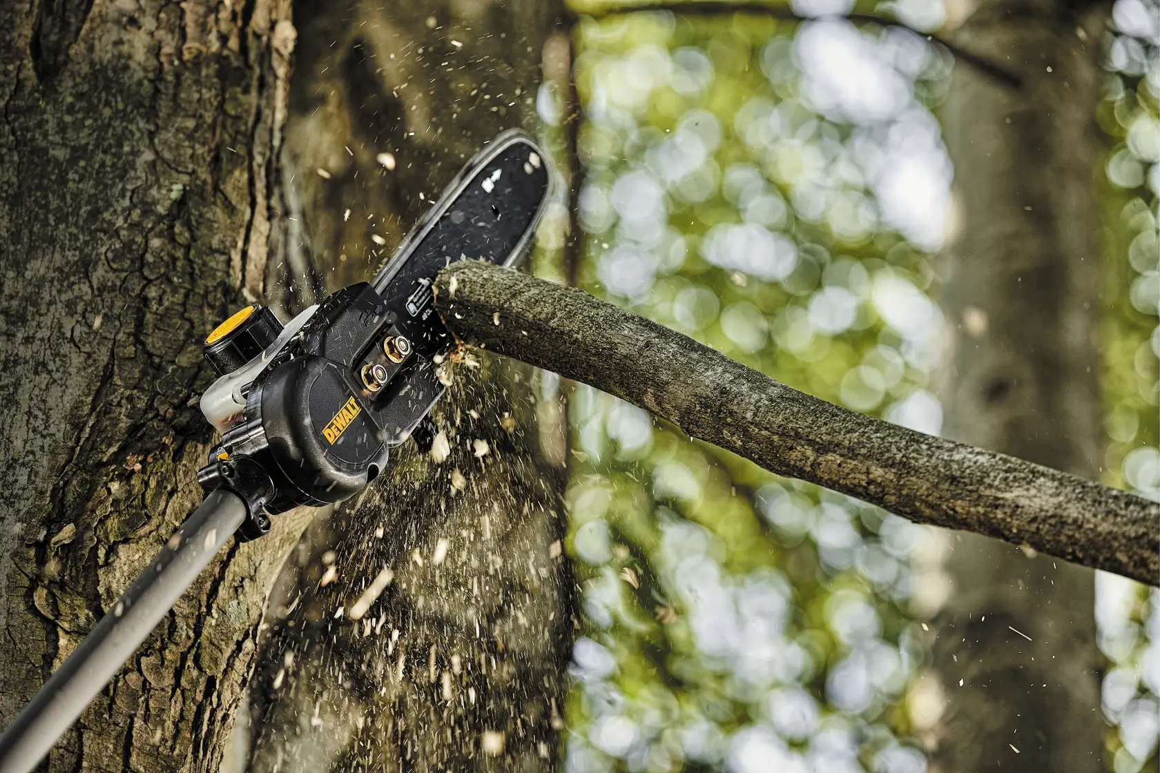 27 cubic centimeters 2 Cycle 10 inch Gas Pole Saw with Attachment Capability being used to cut tree branch.