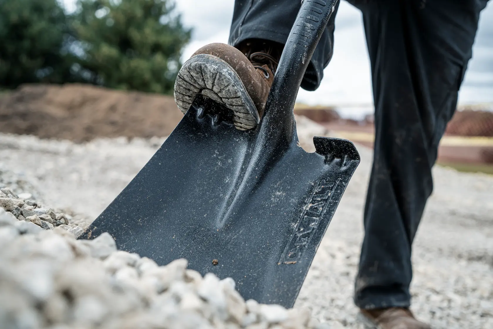 49 inch Wood Handle Transfer Shovel close up shoveling gravel