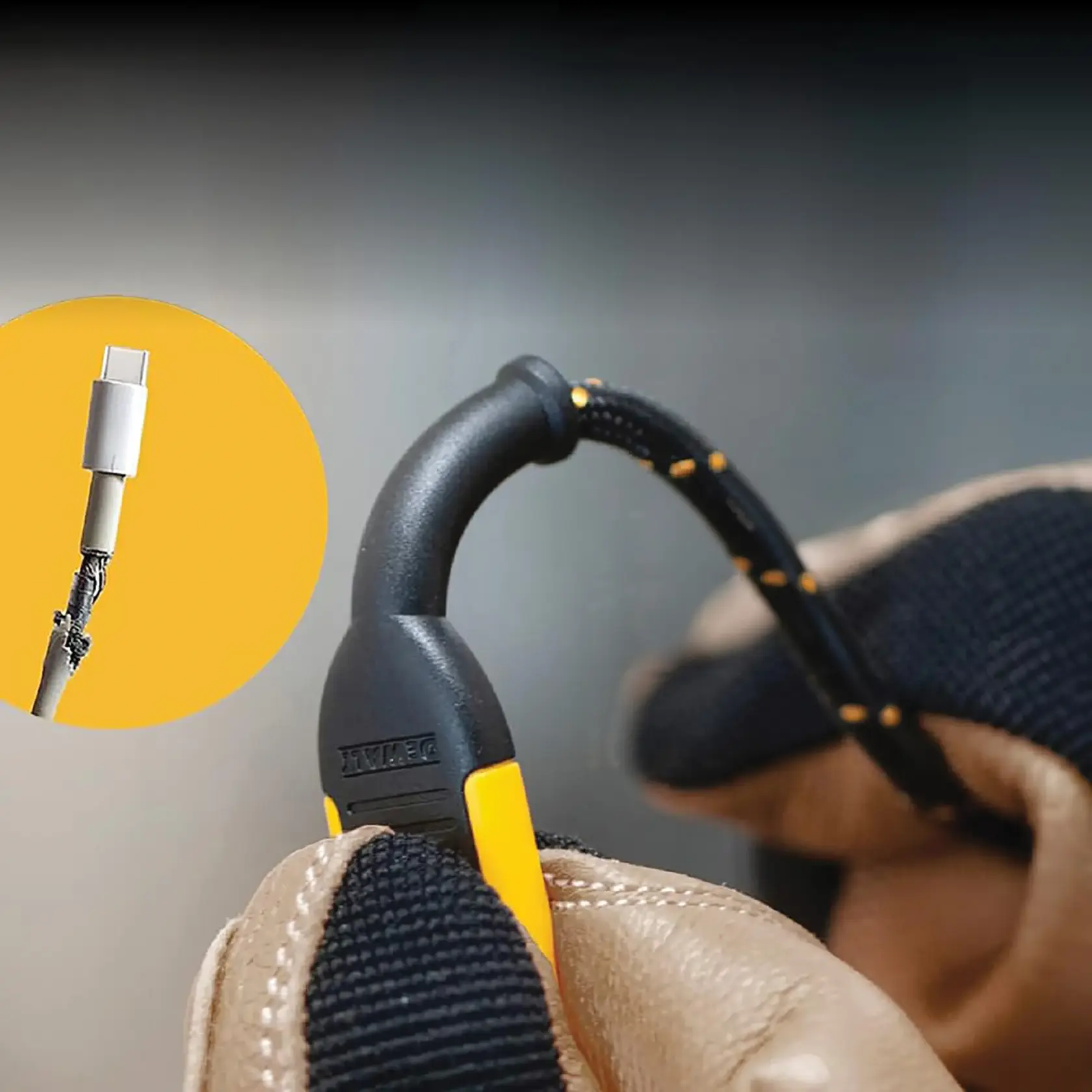 Close-up image of a person wearing work gloves holding a DEWALT-branded black and yellow cable with a reinforced connector. Inset shows a damaged charging cable with frayed wires. The DEWALT cable appears robust and protected.