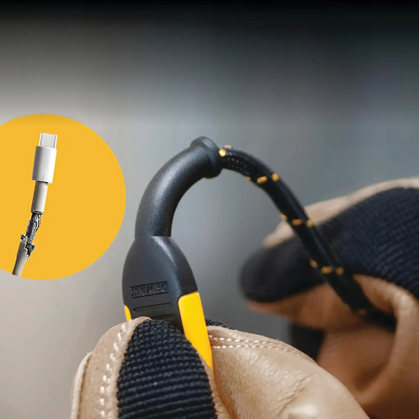 Close-up of a gloved hand holding a DEWALT cable with a reinforced connector. An inset shows a damaged cable with exposed wires for comparison, highlighting the durability of the DEWALT product.
