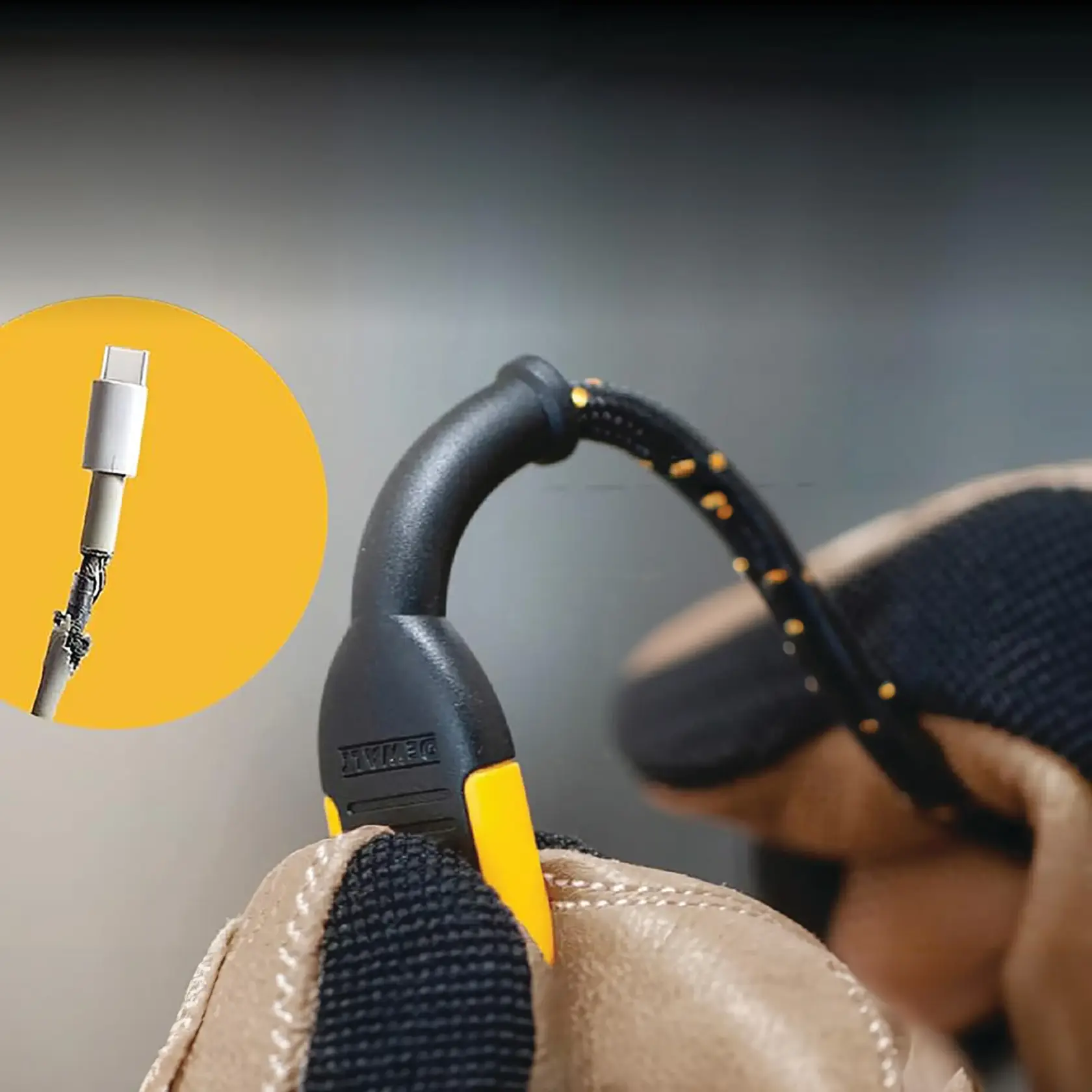 Close-up image of a DEWALT-branded heavy-duty braided USB-C charging cable being held by gloved hands. The cable features reinforced joints for durability. An inset circle highlights a damaged standard charging cable for comparison.