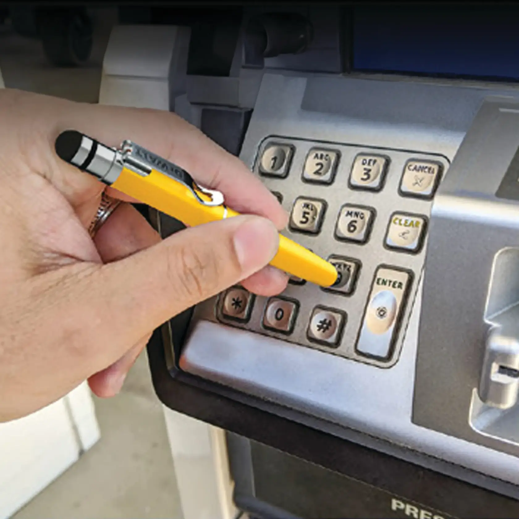 Nylon tap-tip in use as a hands-free method of utilizing an ATM keypad.