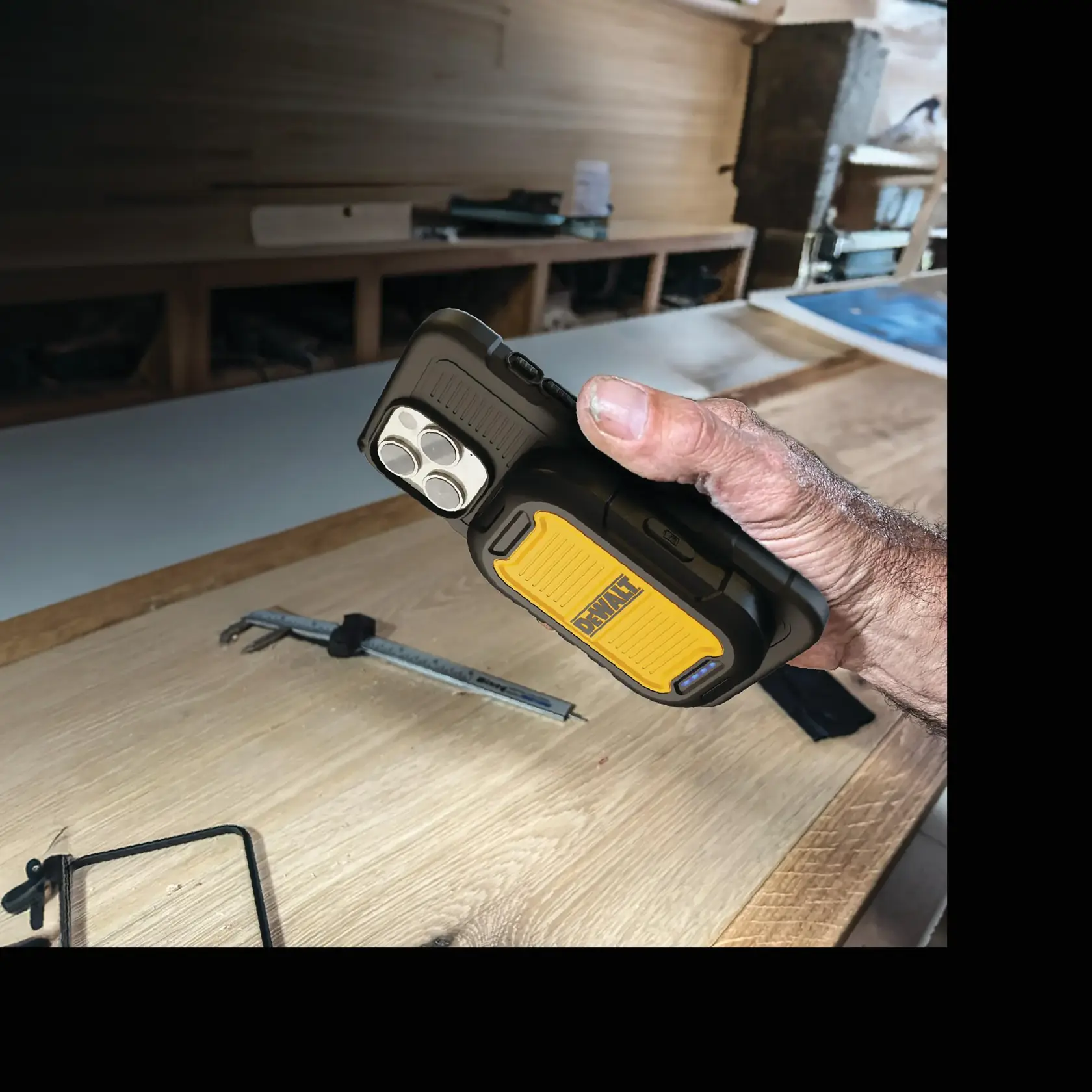 Close-up of magnetic powerbank, featuring a strong magnetic attachment and LED battery indicators.