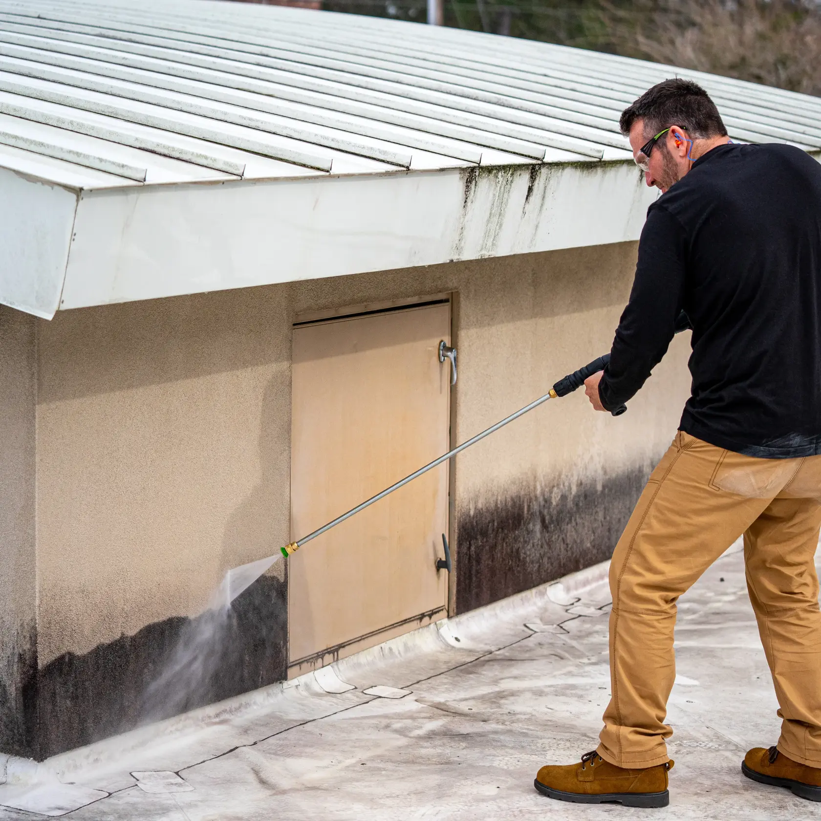 Pressure Washer 31 inch Spray Wand Rated 4500 PSI being used by a person to clean wall mold.