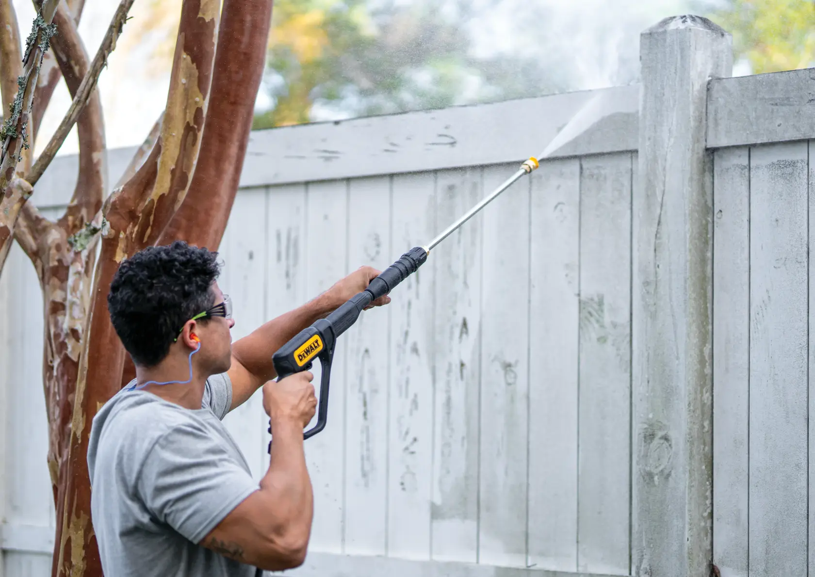 PressuReady 3400 PSI at 2.5 GPM Powered Cold Water Gas Pressure Washer being used by a person on wood fence.