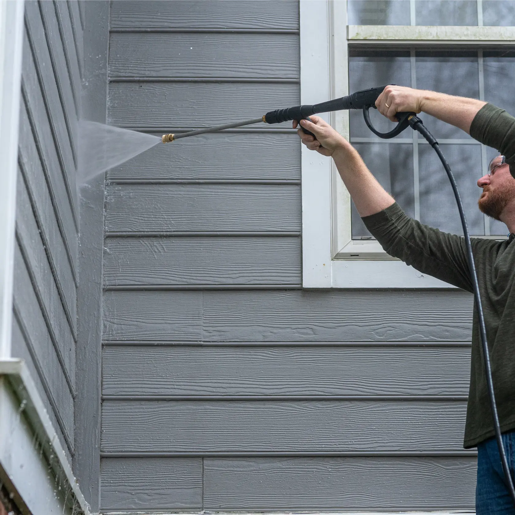 Pressure washing siding with white nozzle