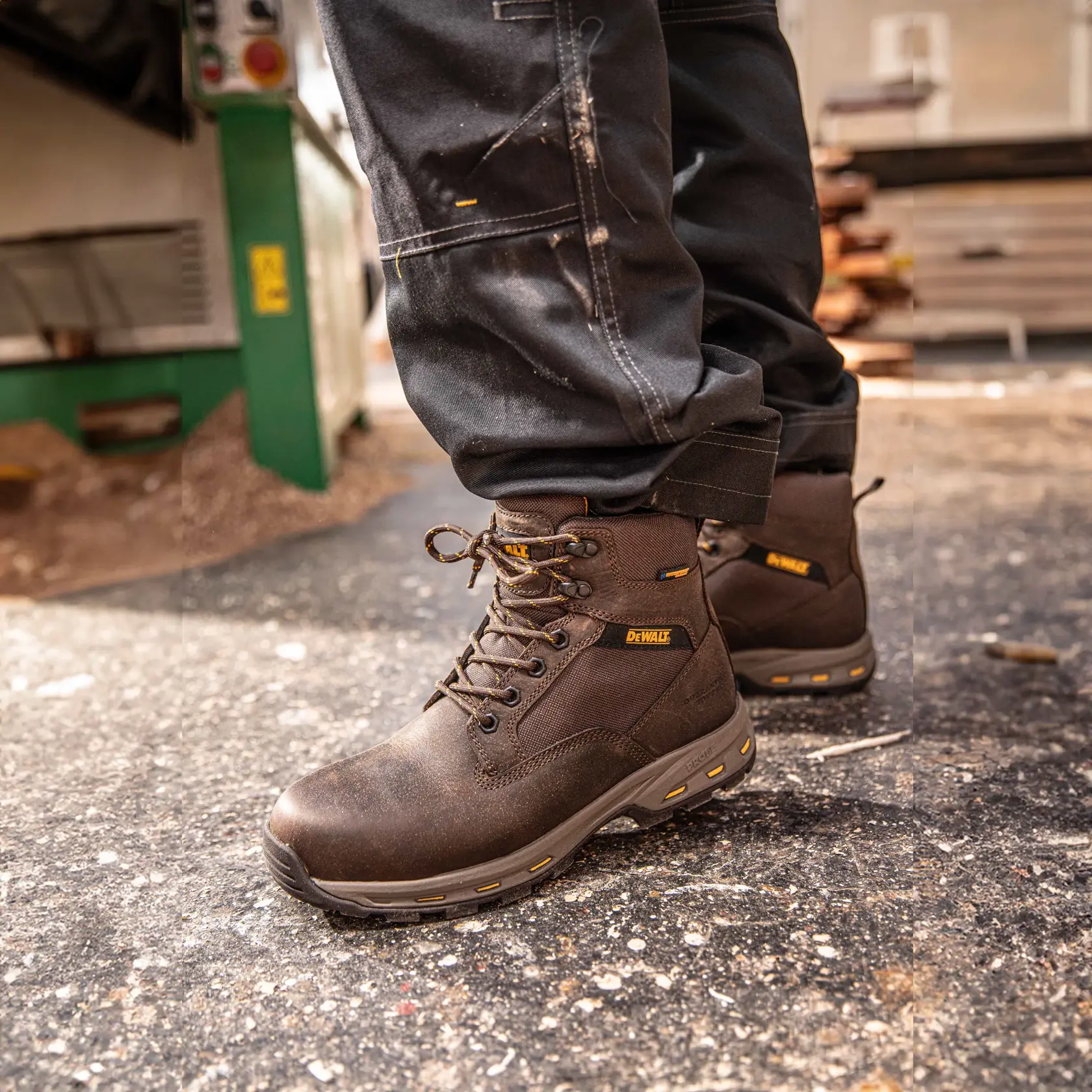 Side view facing left of the DEWALT Halogen Lite men’s safety boot in brown on model on location
