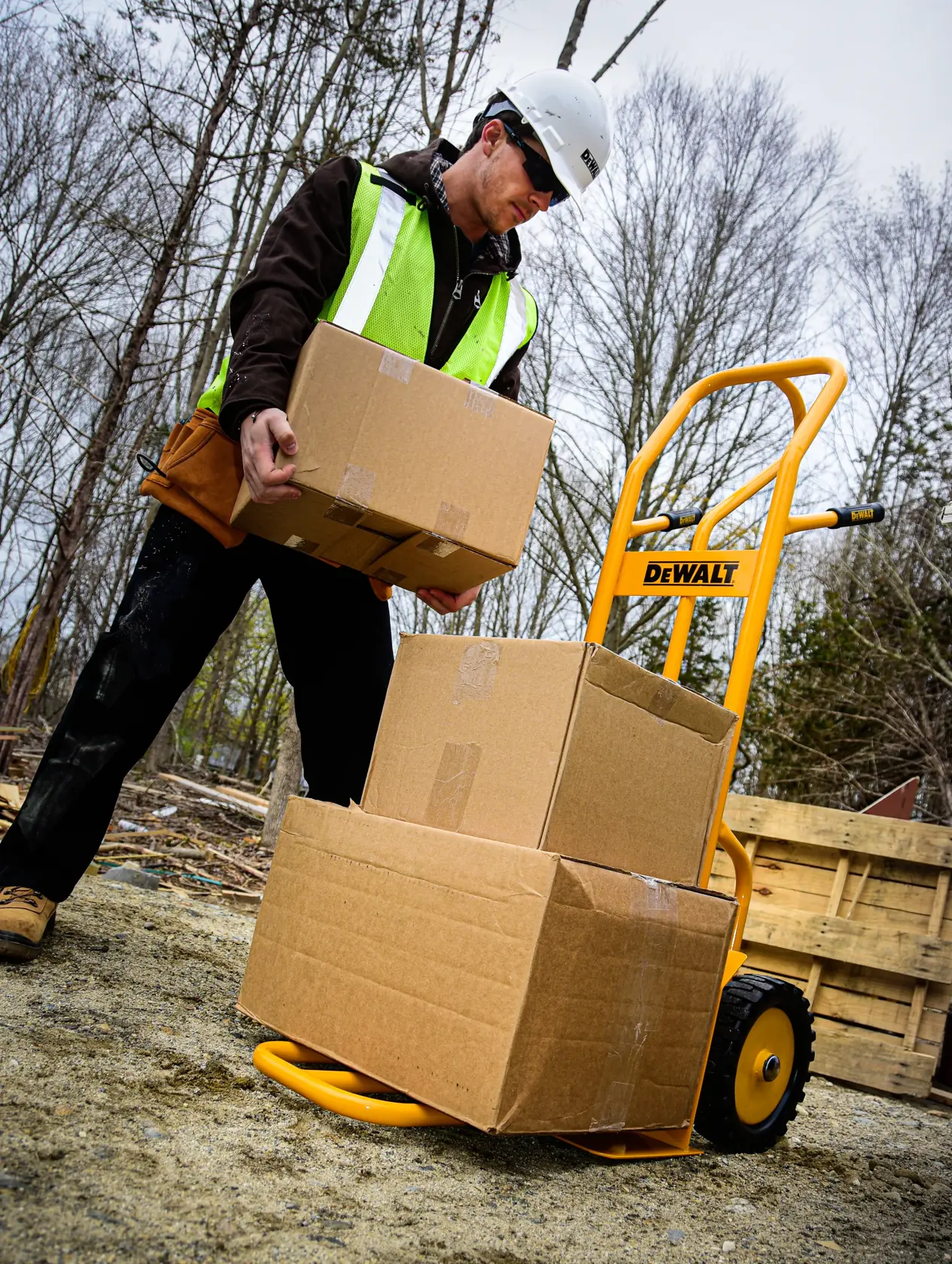 Dewalt DXWT-HT500 4-in-1 Hand Truck application shot - man loading boxes onto truck