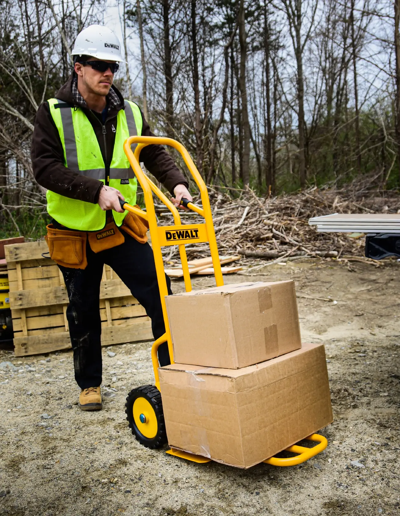 Dewalt DXWT-HT500 4-in-1 Hand Truck application shot - man beginning to pull truck with boxes loaded